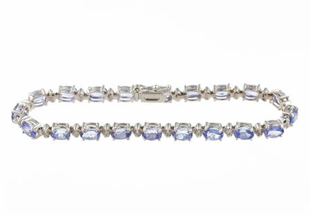 14K Gold Gemstone and Diamond Bracelet: A 7 1/2" length white gold bracelet with oval tanzanite and round diamonds in an alternating line pattern. Total weight is 13.4 grams and it is in new condition.