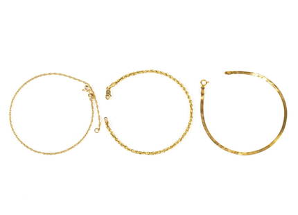 Three 14K Gold Chain Bracelets: The french rope chain bracelet is 7" and the herringbone chain bracelet is 7". A delicate rope chain is 9"in length. The herringbone piece has some crimping damage. Total weight is 4.0 grams.