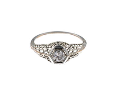 18K Gold and Diamond Ring: A size 7 antique 18k white gold filigree ring with approximately .50 carat diamond. The weight is 1.7 grams.