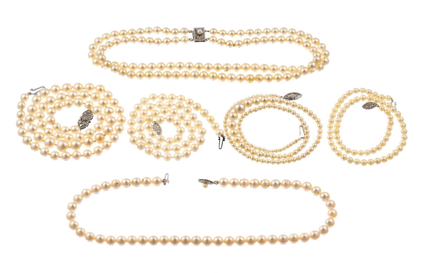 Six Strands of Pearls w/ Gold Clasps: Five have 14k white gold clasps and one has a 10k gold clasp. The pearls range from 13" choker to 21" and one necklace is a double strand.