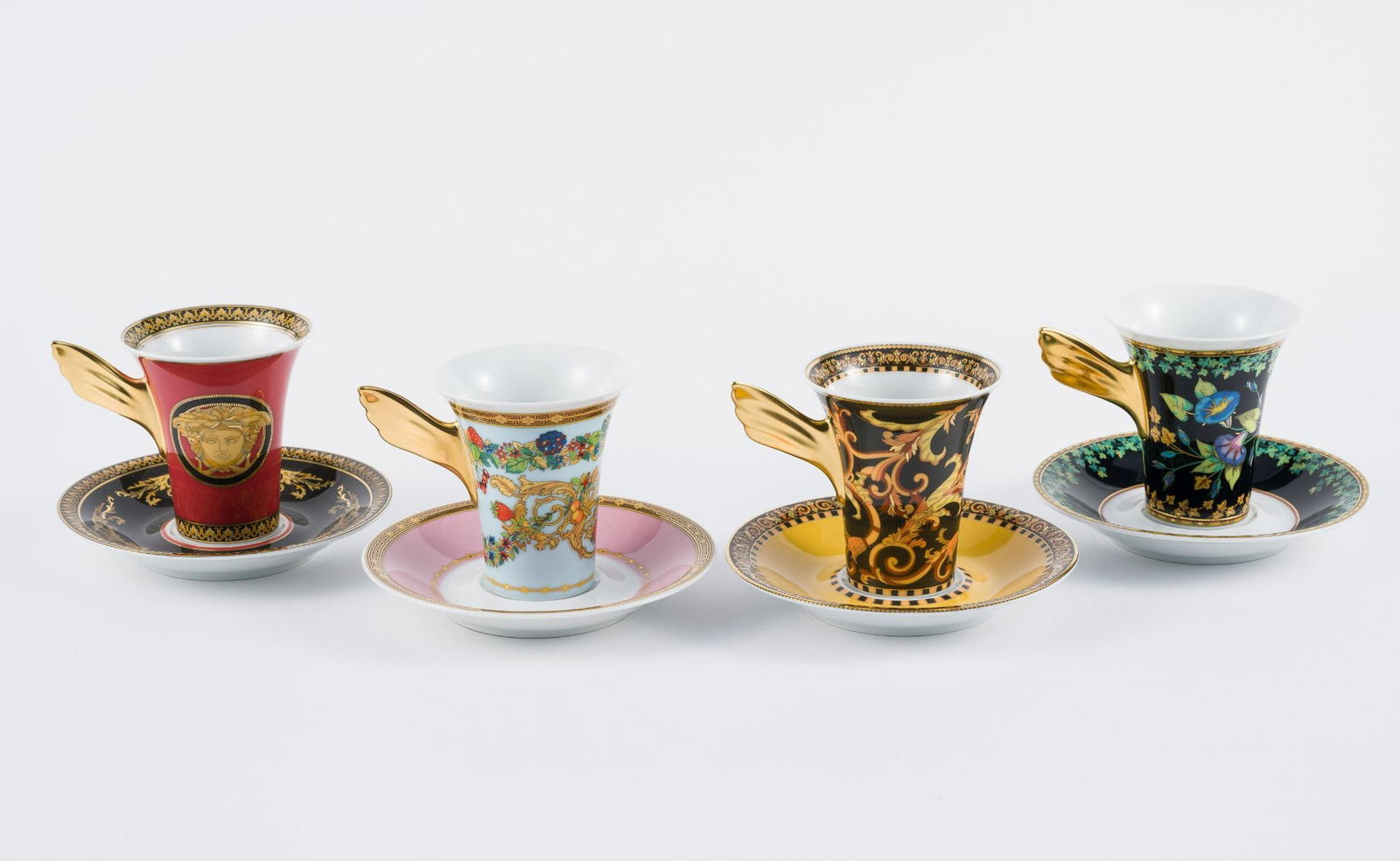 4 Versace Rosenthal Cups & Saucers: All in Versace boxes. Various designs and colors. Boxes measure 6" to 6-1/4" wide x 3-1/2" to 3-3/4" high.