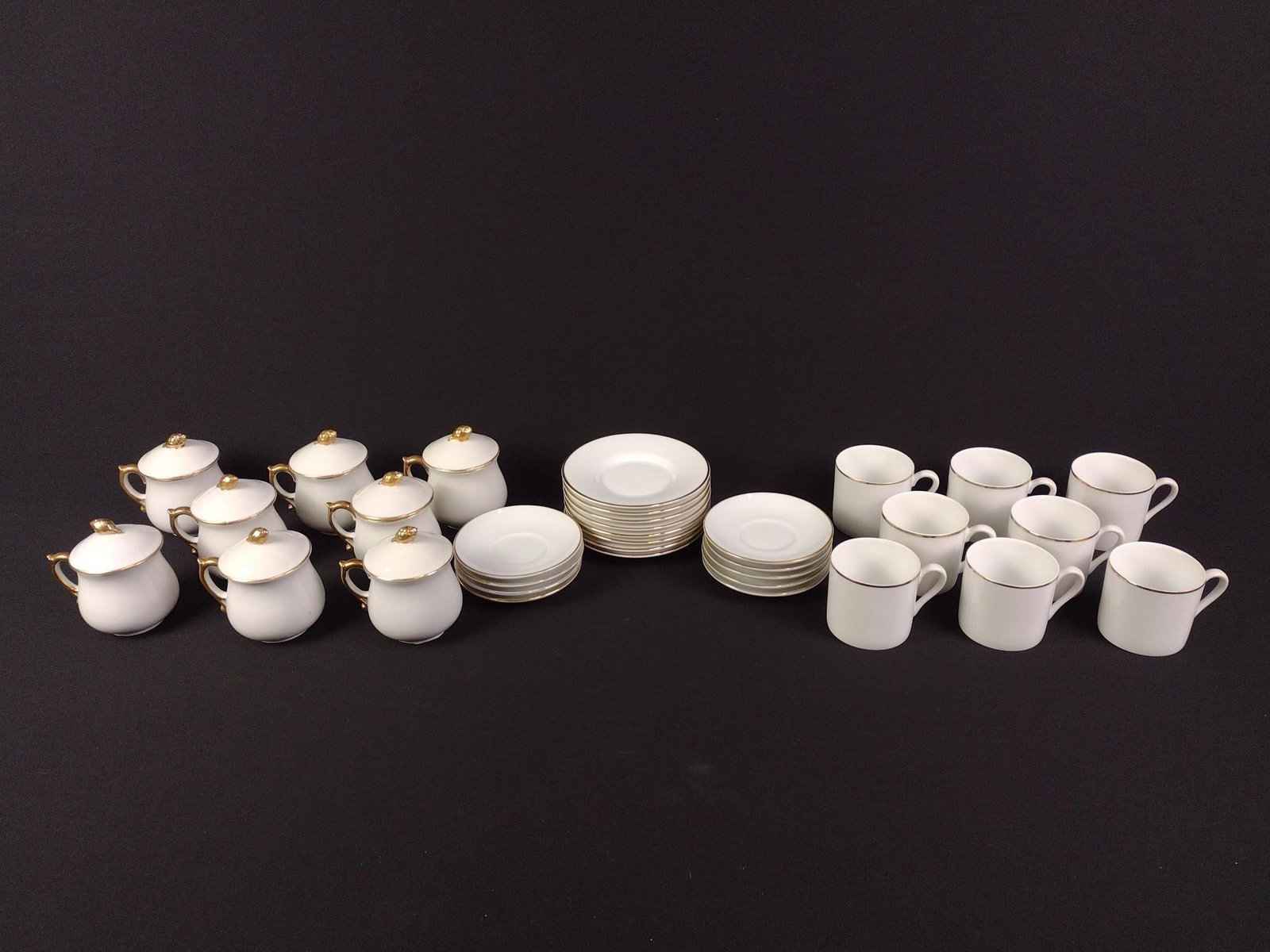 16 Pcs Tiffany and Co. Cups and Saucers and 17 Pcs JSC Cream Cups and Saucers: 16 pcs Tiffany and Co. cups and saucer set. 17 pcs JSC set includes 8 "Pot de Cremes," 8 "Golden Heirloom" saucers, and 1 matching "Pot de Creme" saucer. Overall good condition. Saucers are from 4" to