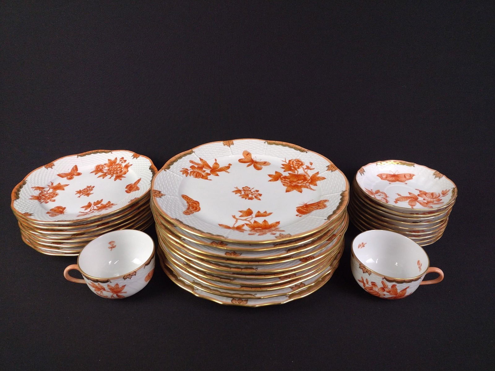 29 Pcs Herend Hungary "Fortuna Rust": Includes 10 dinner plates, 8 appetizer plates, 9 saucers, and 2 cups. Makers mark on back. Overall good condition. Smallest plate is 5-1/2" in diameter, largest plate is 10".