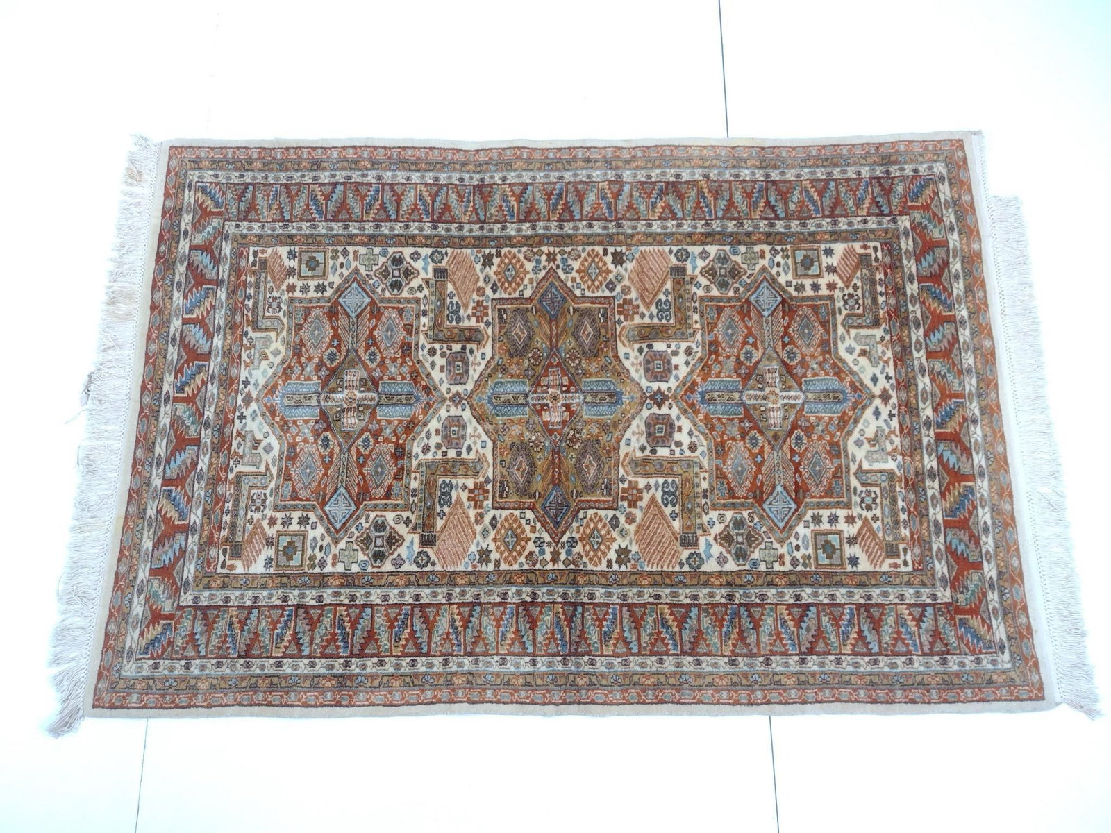 Area Rug: NOT ELIGIBLE FOR IN-HOUSE SHIPPING - See Terms for Shipping Options. 6'3" long X 4'3" wide. Has some loss to fringe. No manufactures name found.