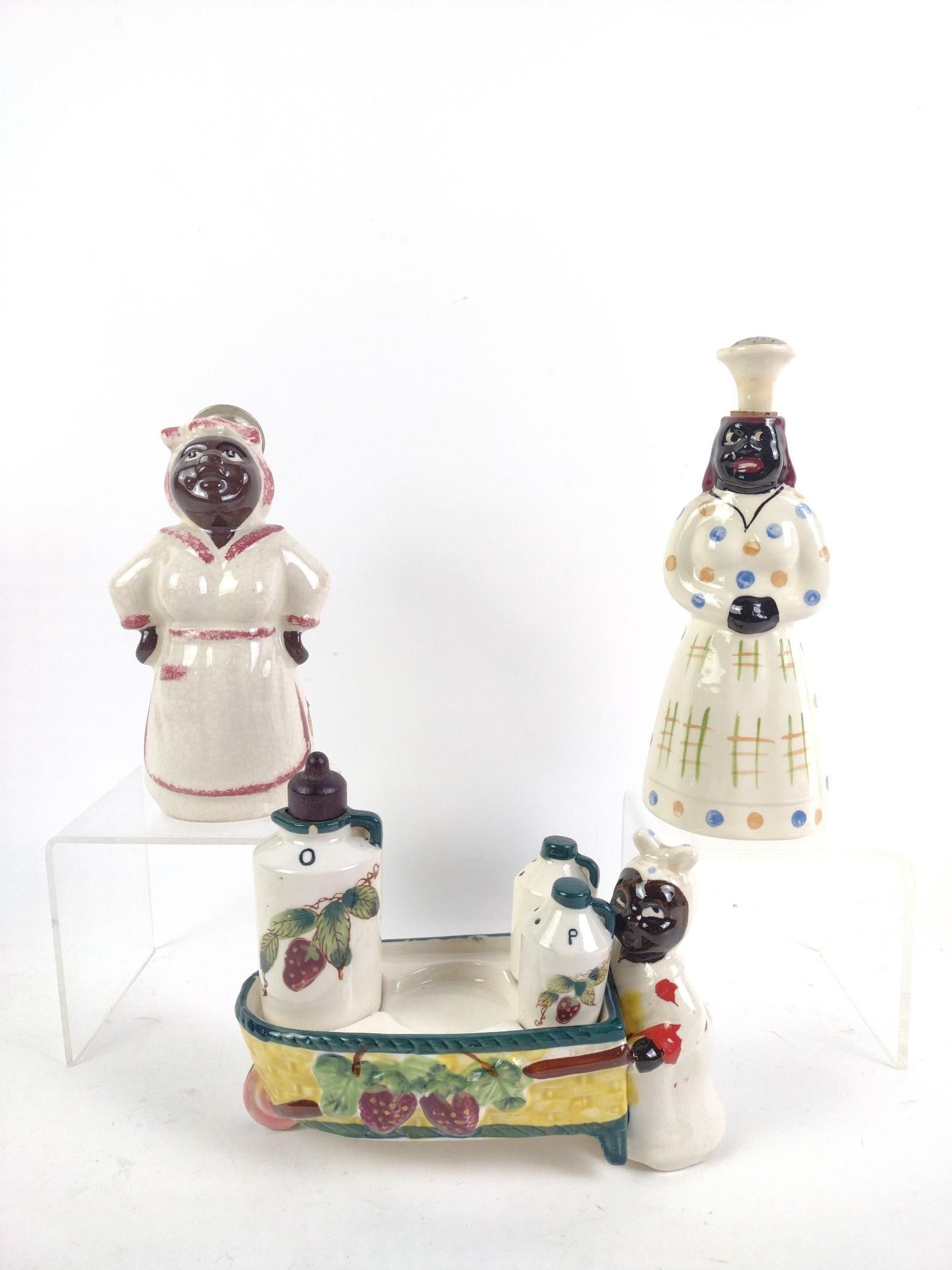 2 Vintage Black Americana Salt and Pepper Shakers w/ Holder: Includes 2 mammy salt and pepper shakers, not a set, and 1 wheelbarrow seasoning holder, missing one container. One marked "Relco, Hand Decorated, Japan." Overall good condition, with normal wear and 