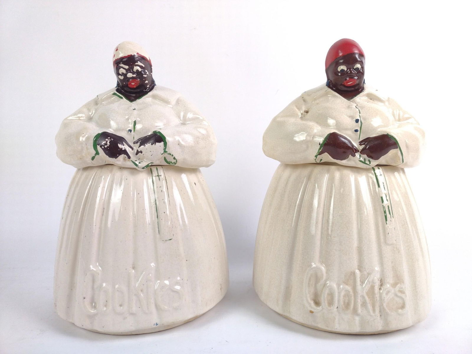 2 McCoy Pottery Black Americana Mammy Cookie Jars: Overall decent condition with chipped paint and other wear and tear associated with age. Both 11" tall and 7-1/2" wide.