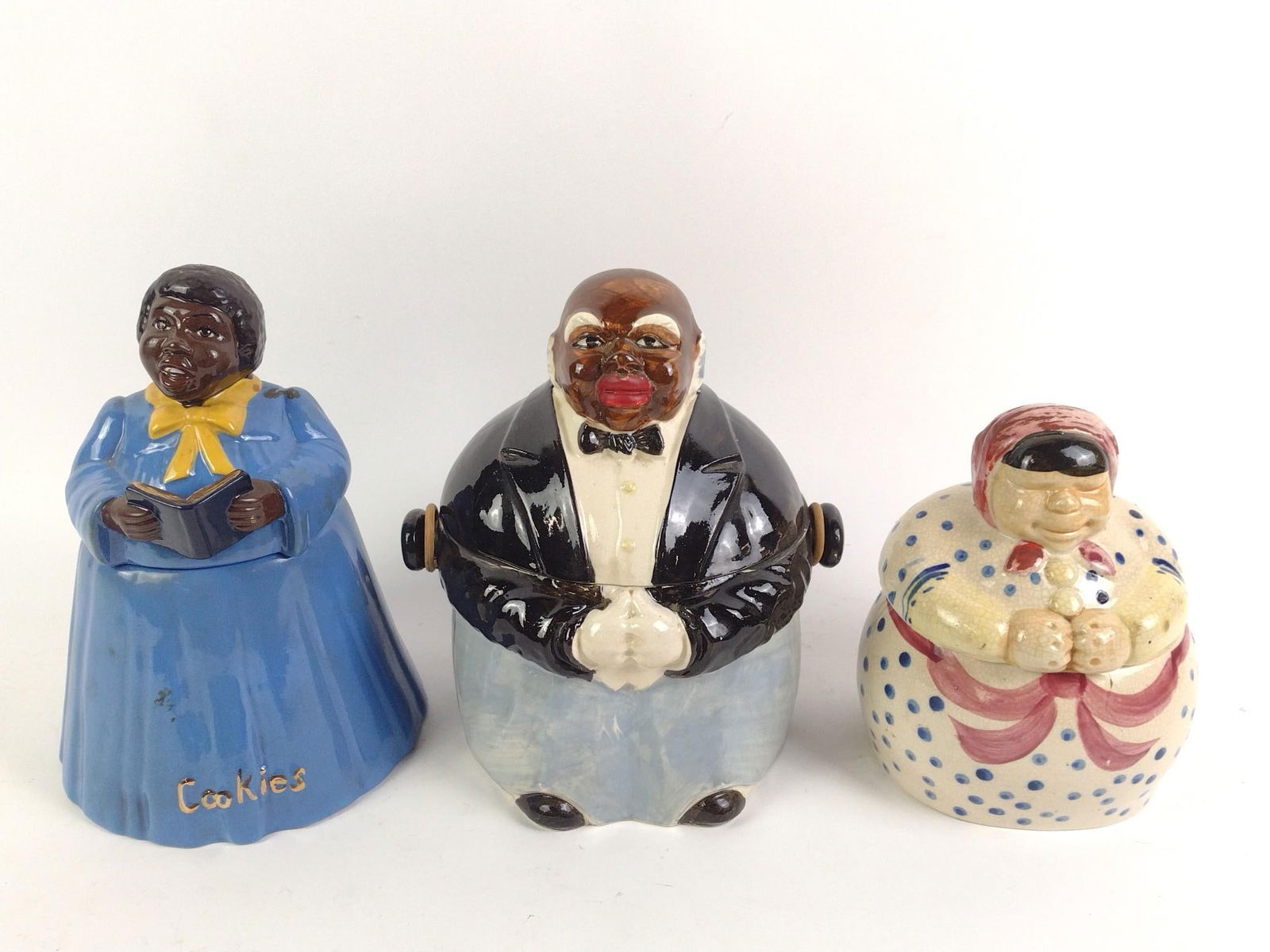 3 Black Americana Cookie Jars incl Miller: Butler and mammy cookies jars made in Japan. Sister Ruth cookie jar marked as 16/250. Overall good condition, with general wear and tear associated with age. Mammy cookie jar has had repair work done.