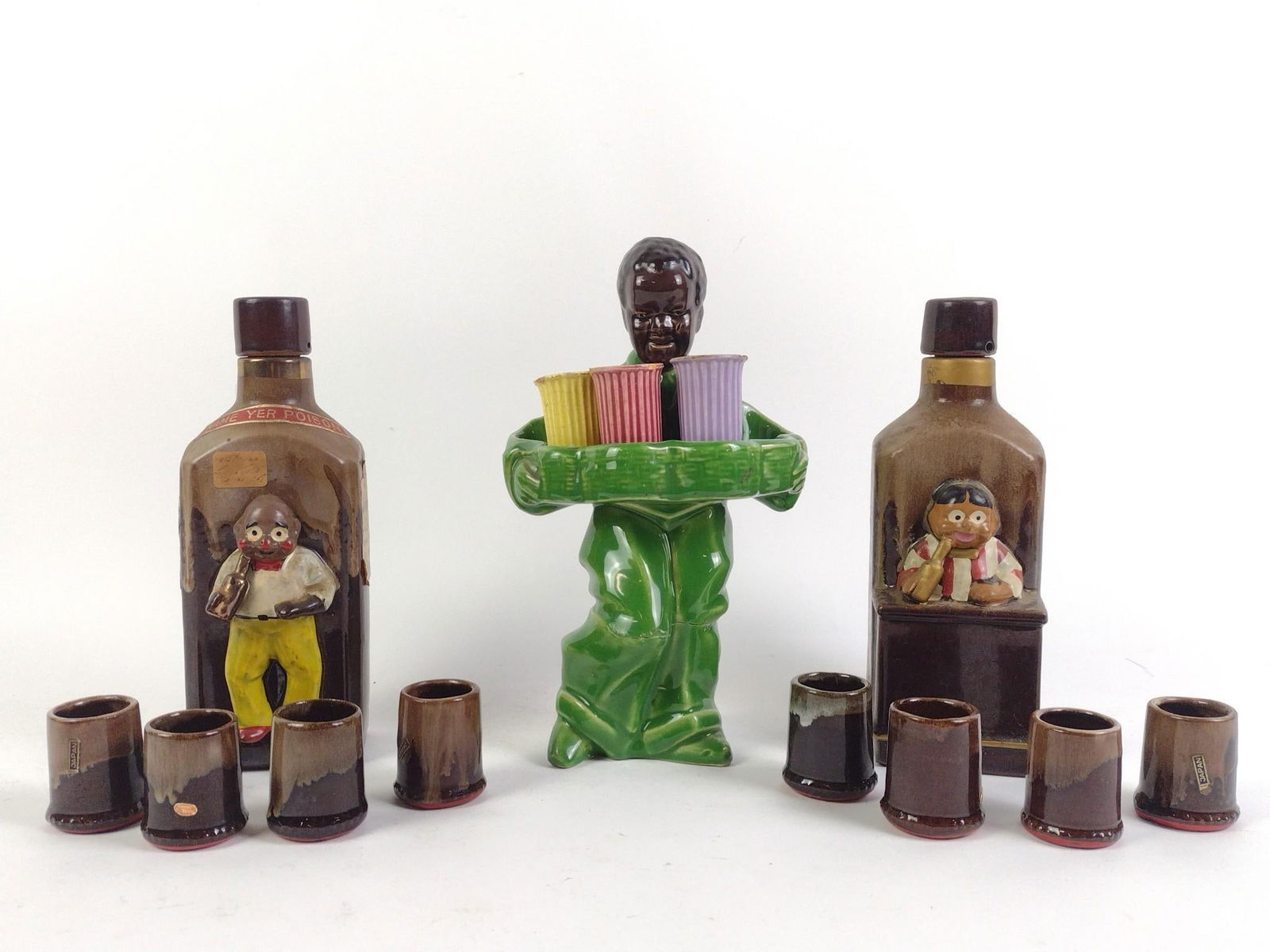 3 Black Americana Decanters incl El Stinko: Includes matching shot glasses. Overall good condition with wear and tear associated with age. Green decanter had repair work done to cork. From 8-1/2" to 9-3/4" tall.