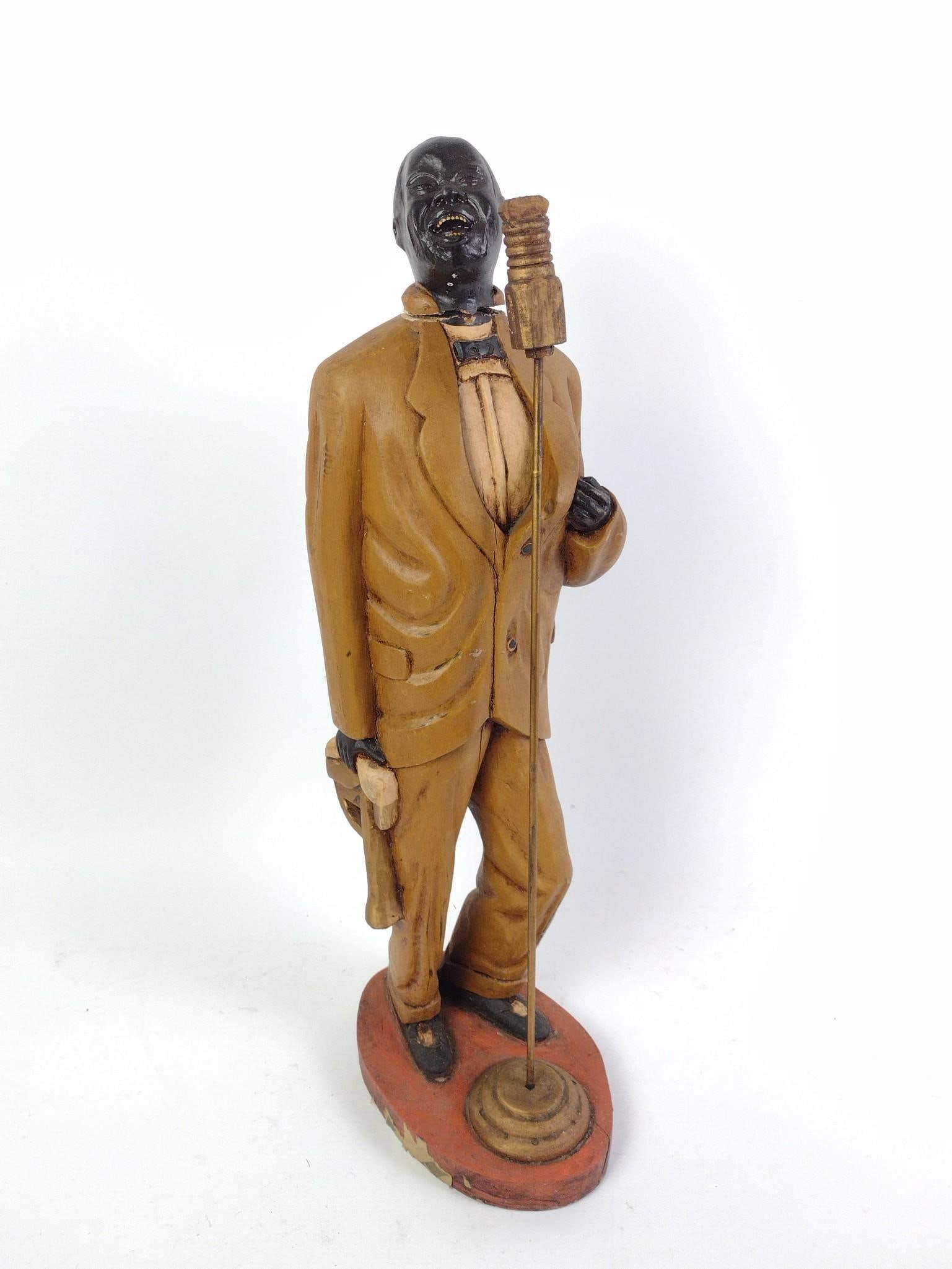 Carved Wooden Louis Armstrong Statue: NOT ELIGIBLE FOR IN-HOUSE SHIPPING - See Terms for Shipping Options. Shows signs of wear and tear associated with age. 22" tall, 8-1/2" long, 6-1/2" wide.