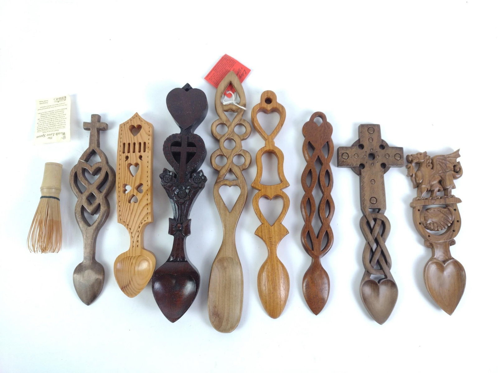 8 Modern Welsh Love Spoons and 1 Matcha Whisk: 8 decorative carved wooden spoons and 1 Matcha whisk. All in good condition, mixer shows signs of use. From 4-1/2" to 13-1/2" long and 1-1/2" to 3" wide.