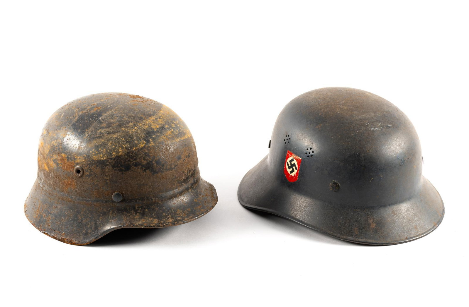 2 WWII German Helmets: Includes a WWII Era German Civil Defense helmet and a WWII German Beaded M-40 helmet. One still has a liner in it. Both 6-1/2" tall. From 11-1/4" to 12-1/2" long and 9-1/2" to 10" wide.