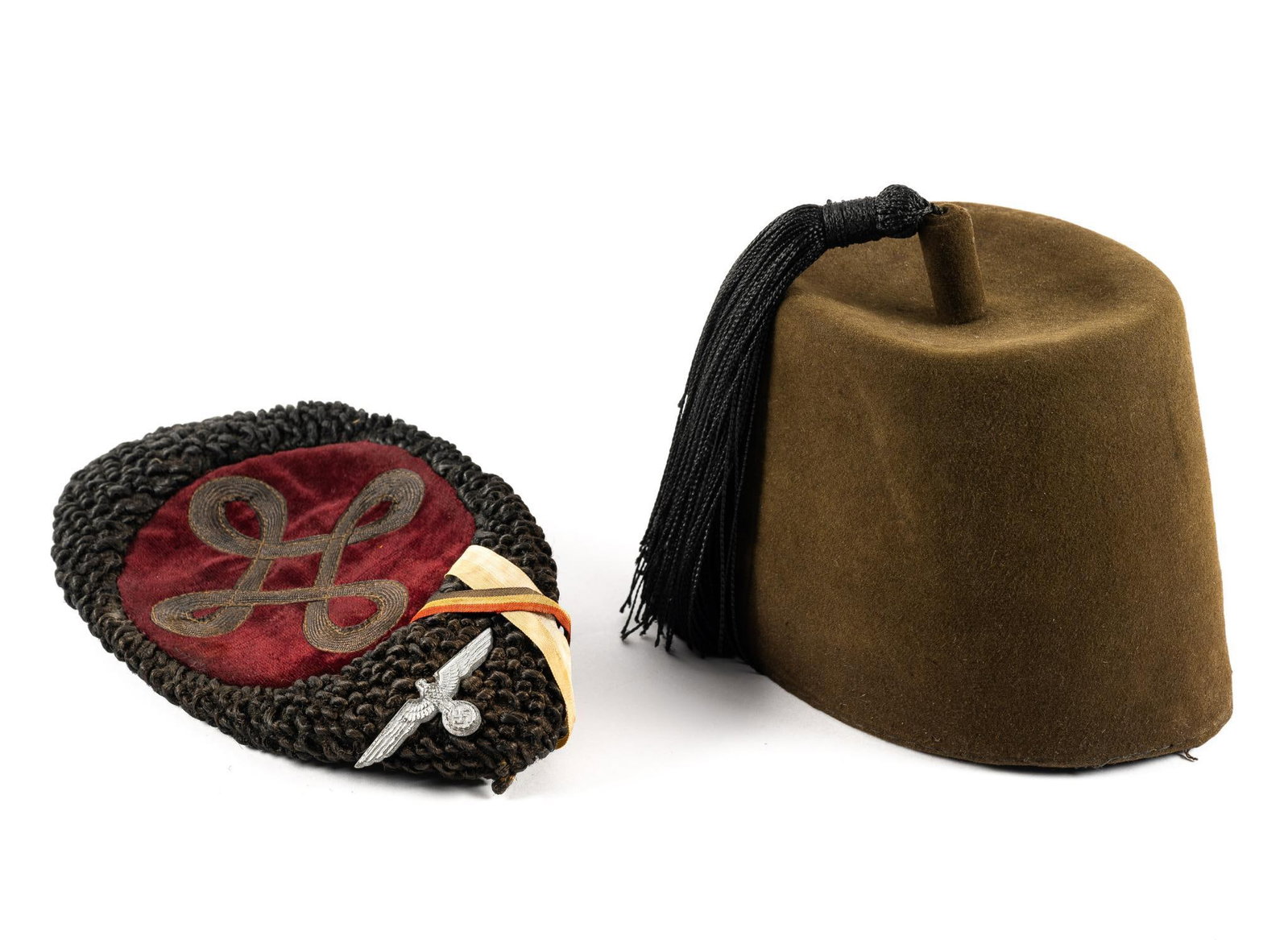 German Fez and German Cossack: Includes a postwar or pre-war German fez and a German cossack. Both have normal wear and tear associated with age. From 2-1/2" to 6-1/4" tall, 7-1/2" to 8-1/2" long, and 5-1/2" to 6" wide.