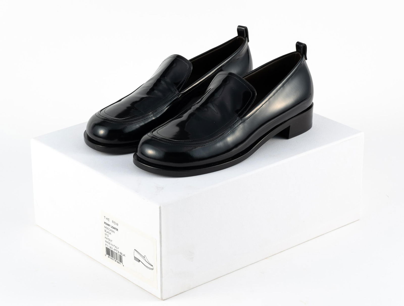 The Row Patent Leather Penny Loafers: Size 37.5 black moccasin dress shoe. Size 7 women's. Made in Italy. New in the original box. New cost approximately $1,200.
