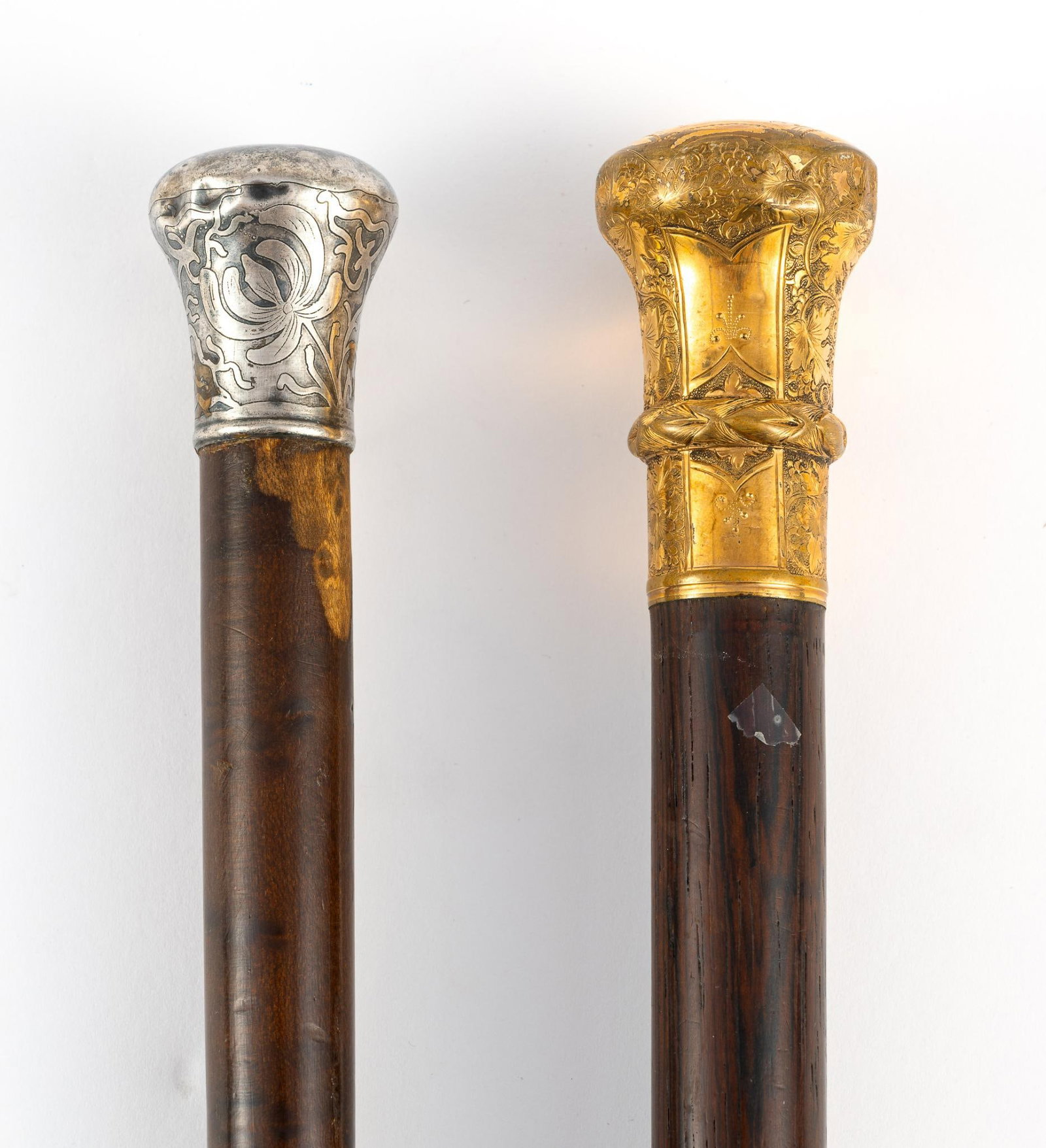 Two English Canes with Sterling and Gold-Filled Handles: The wood canes are 25" and 36". One has a fold filled handle showing wear-through and the second has an engraved handle marked sterling. Both are from the 1800's.