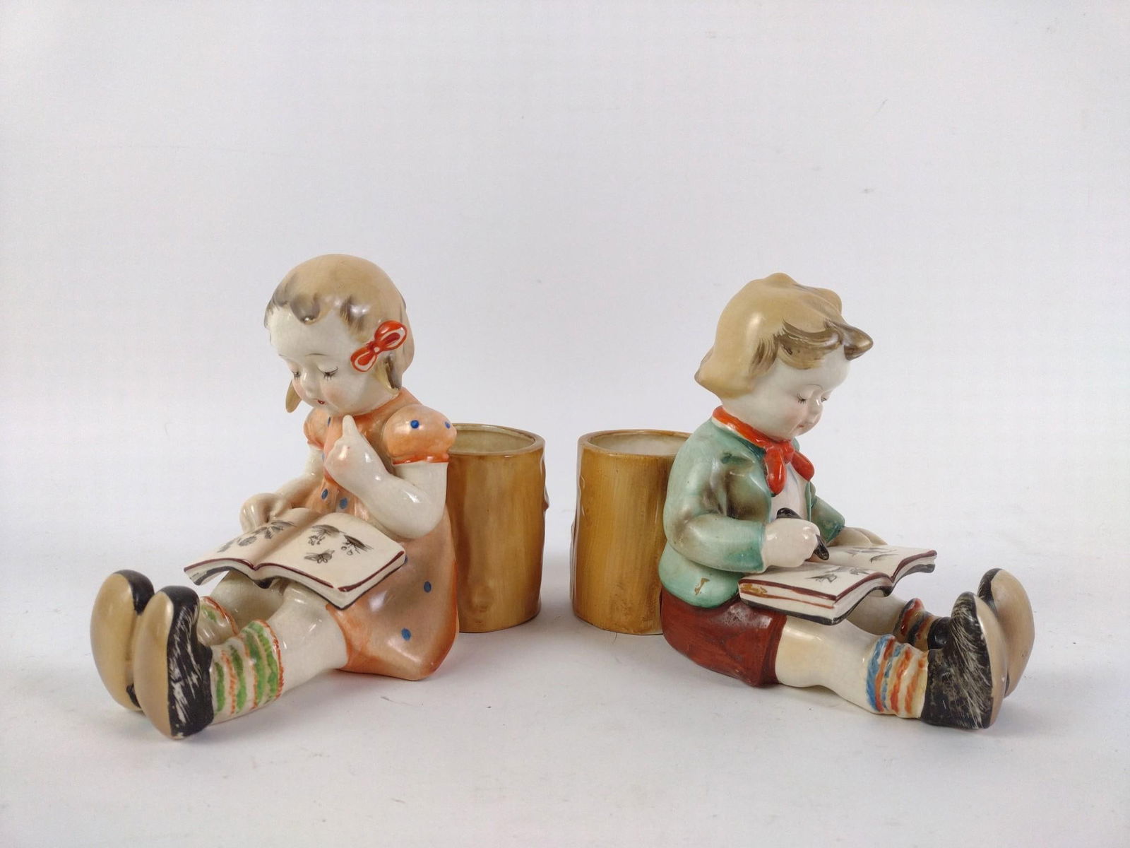 Hummel Style Boy and Girl Reading Toothpick Holders: Normal signs of wear and tear associated with age. Both approximately 7" long, 3-1/2" wide, and 5-1/2" tall.