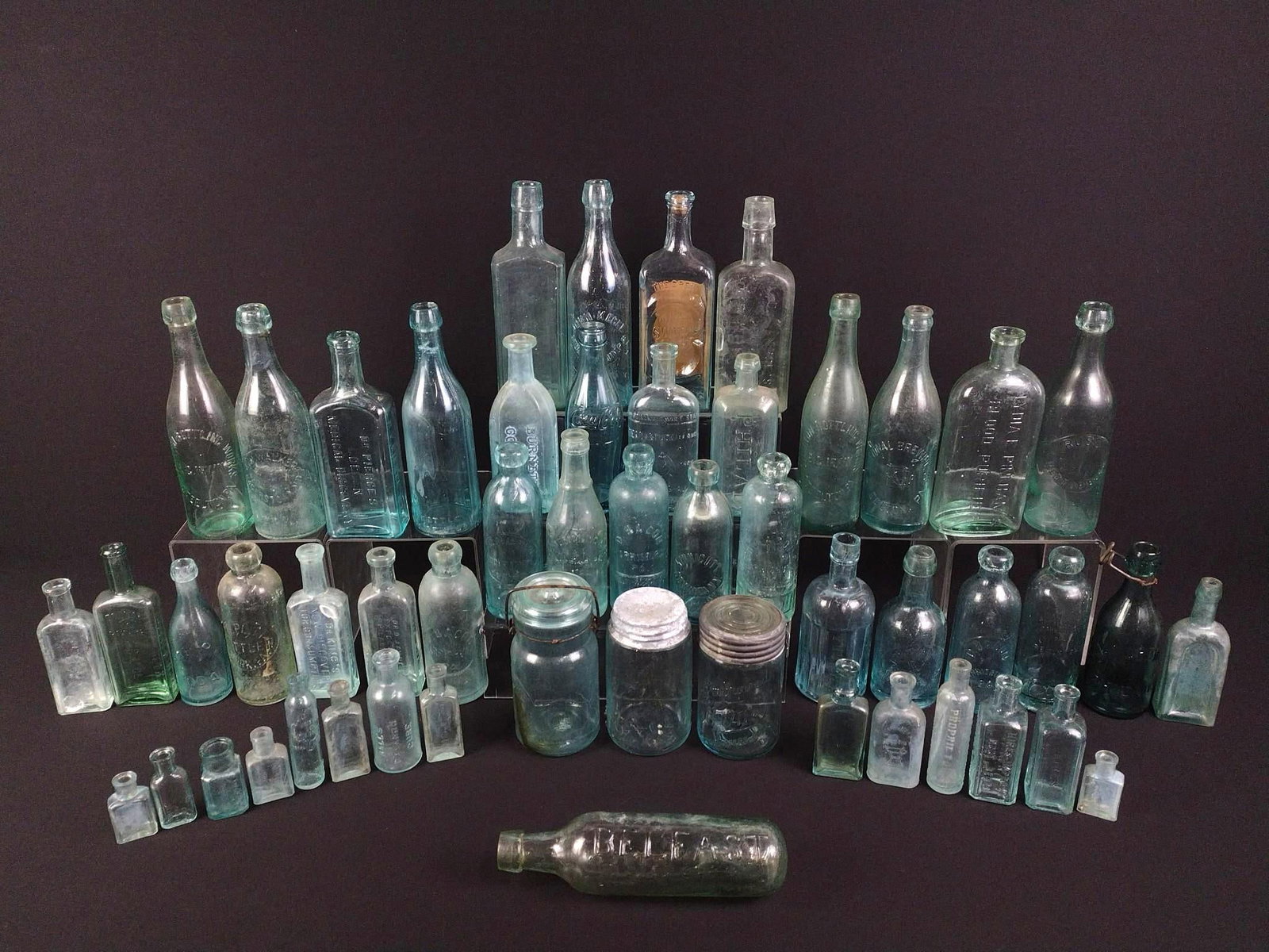 Grouping of Antique Aqua Glass Bottles: NOT ELIGIBLE FOR IN-HOUSE SHIPPING: See Terms for Shipping Options. Aqua glass most common in US manufacturing prior to 1920s. Variety of mouth-blown and machine made bottles. Used for advertising and