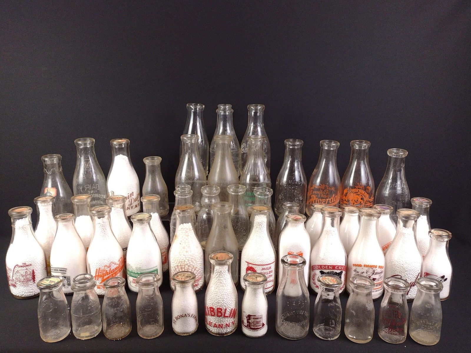 Grouping of Vintage Clear Glass Dairy Bottles: NOT ELIGIBLE FOR IN-HOUSE SHIPPING: See Terms for Shipping Options. Includes Hoffman's, Hardick's Dairy Farm, Harrisburg Dairies, Pine Grove Dairy, and more. Used to bottle milk and cream. Many have i