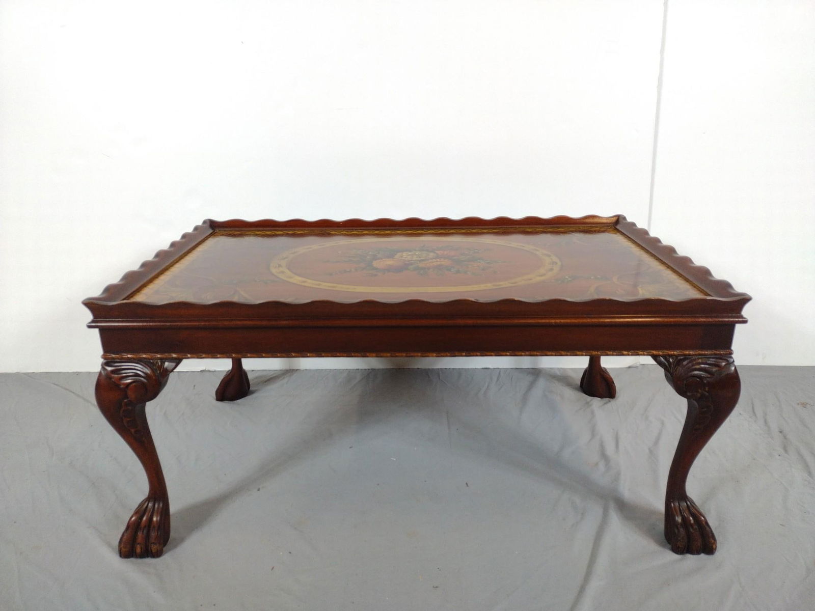 Colonial Revival Coffee Table: NOT ELIGIBLE FOR IN-HOUSE SHIPPING: See Terms for Shipping Options. Four hairy paw feet supporting a tray top with inlaid floral decoration. 36-1/2" wide X 22" deep X 17" high. Has some light scratche