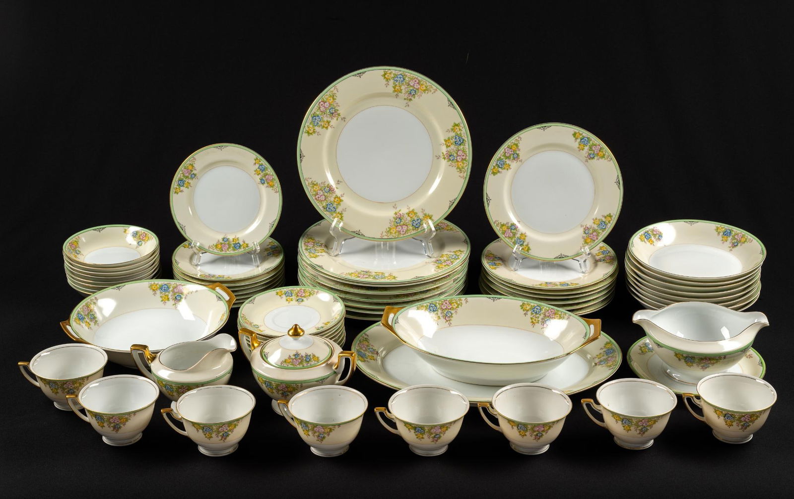 62 Pcs Meito China Set: 8 each of dinner plates, salad plates, appetizer plates, saucers, teacups, big bowls, and small bowls. Also includes 6 serving dishes. Wear associated with age. Marked "Made in Japan" on back. Plates