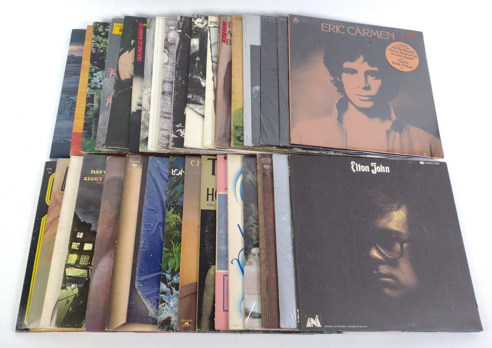 Vinyl Records of Various Genres: Includes David Bowie, Elton John, Fleetwood Mac, Creedence Clearwater Revival, Queen, and more. Normal wear and tear associated with age.