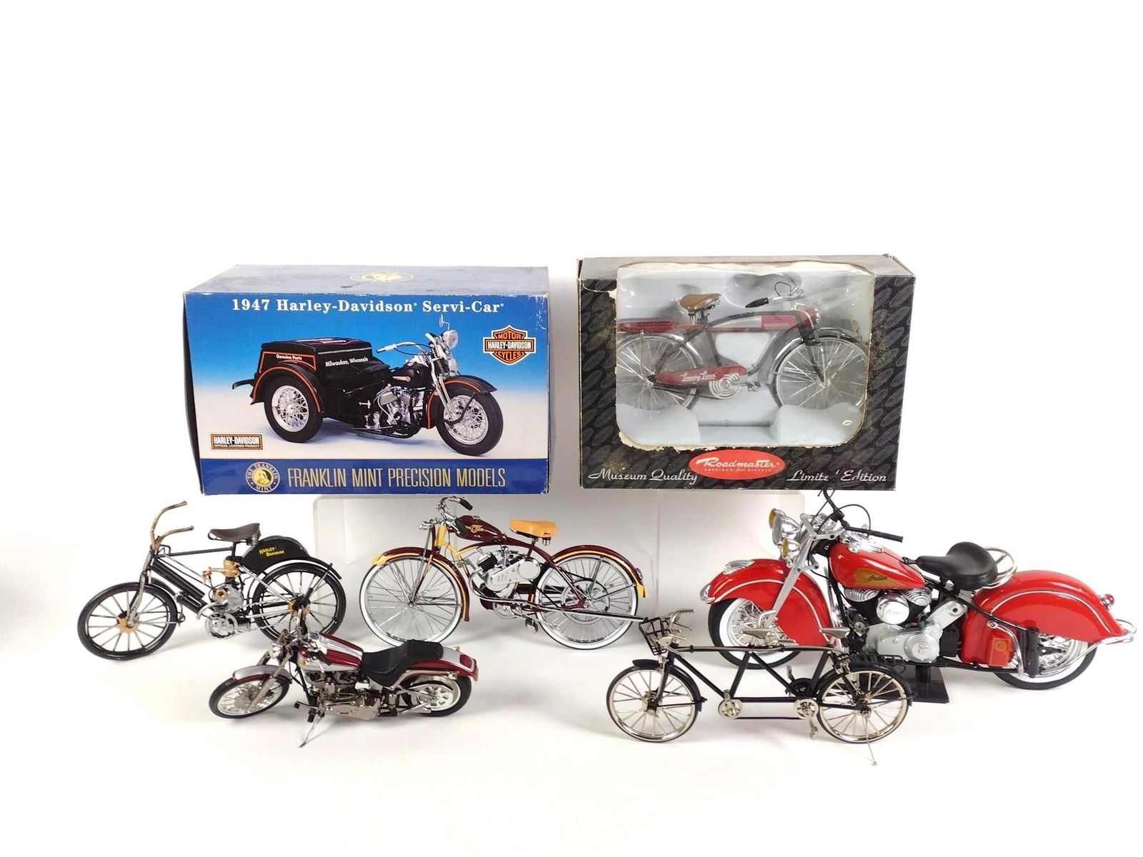 7 Toy Motorcycles and Bicycles incl Harley-Davidson: Two in original boxes. Wear and tear associated with age. From 9-1/2" to 16" long and 5" to 9" tall.