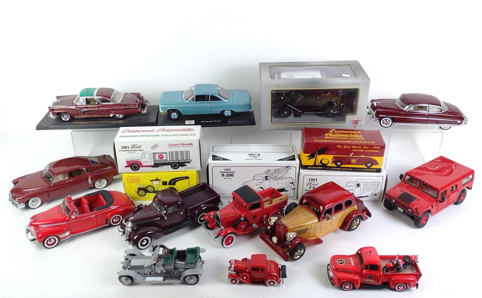 18 Toy Cars and Trucks incl Ertl: Also includes Maisto, Hummer, Ford, and more. Most die cast, some in original boxes. Some wear and tear associated with age. From 5-1/2" to 12" long and 2" to 6-1/4" tall.