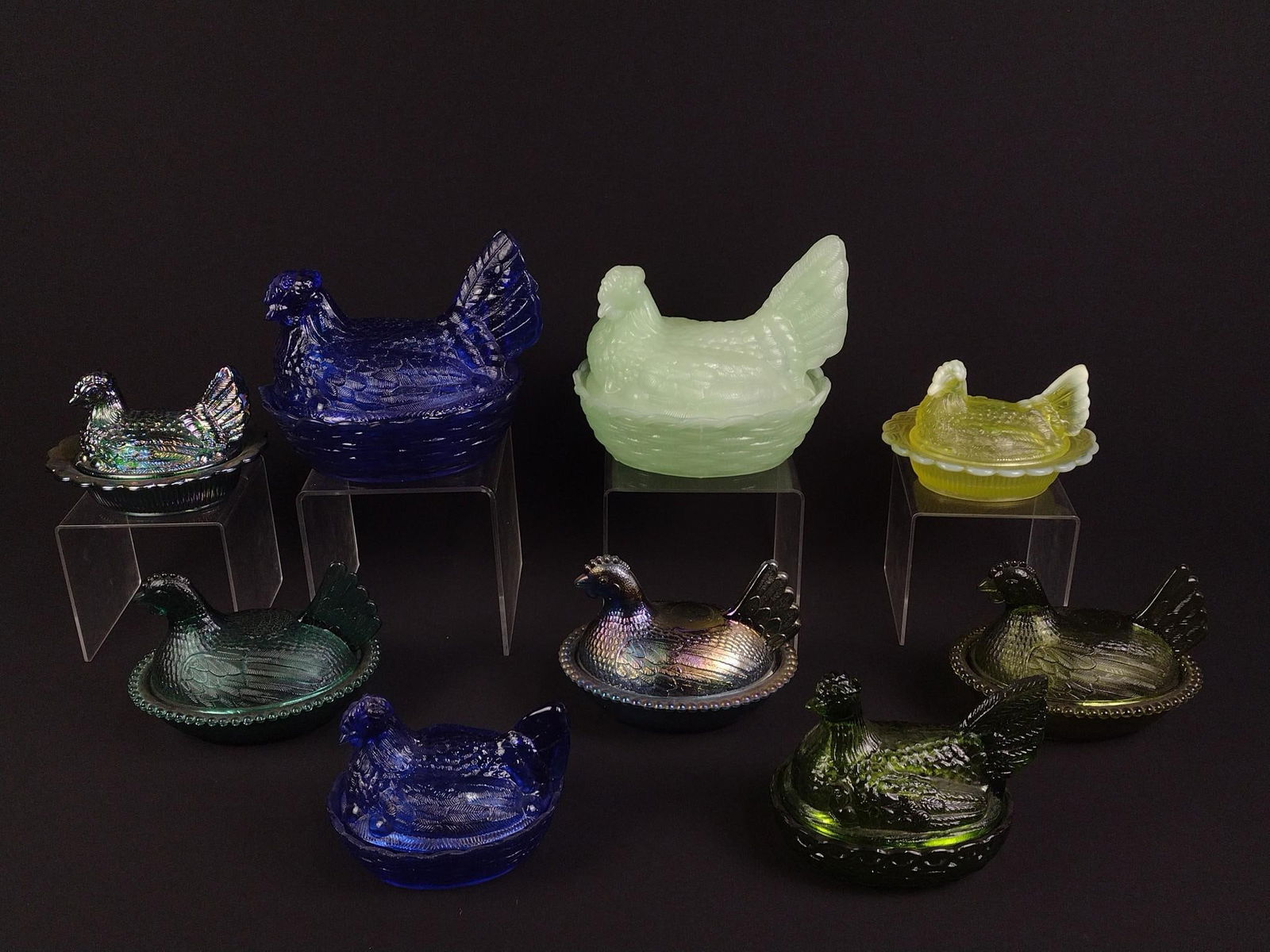 9 Glass Hen on Nest: Yellow, green, and blue glass. Overall good condition with some wear and tear associated with age. From 6" to 8" wide and 4" to 7-1/2" tall.