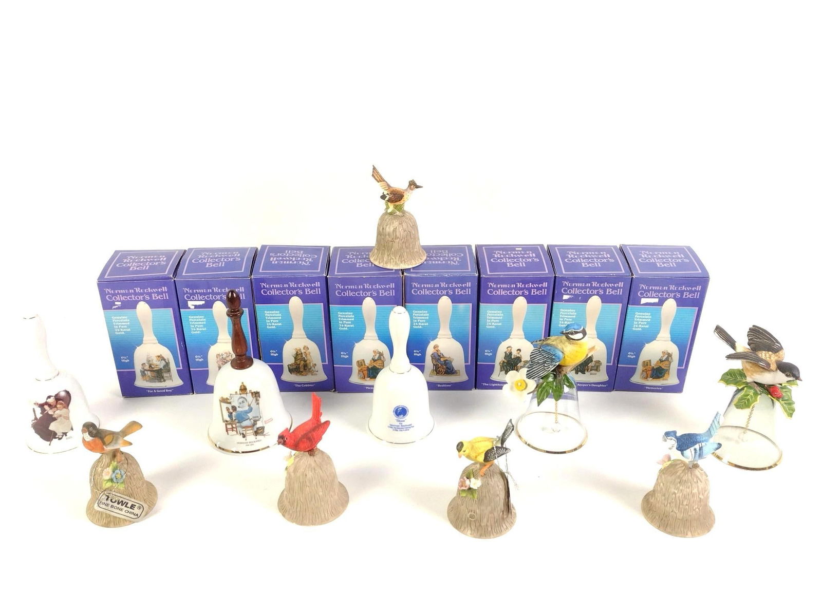 18 Collector Bells incl Norman Rockwell: Includes 8 Norman Rockwell Collector's Bells in original boxes, 3 Norman Rockwell bells without boxes, 2 Franklin Mint glass and ceramic bird bells, and 5 Towle Fine Bone China birds. From 4-1/2" to 7
