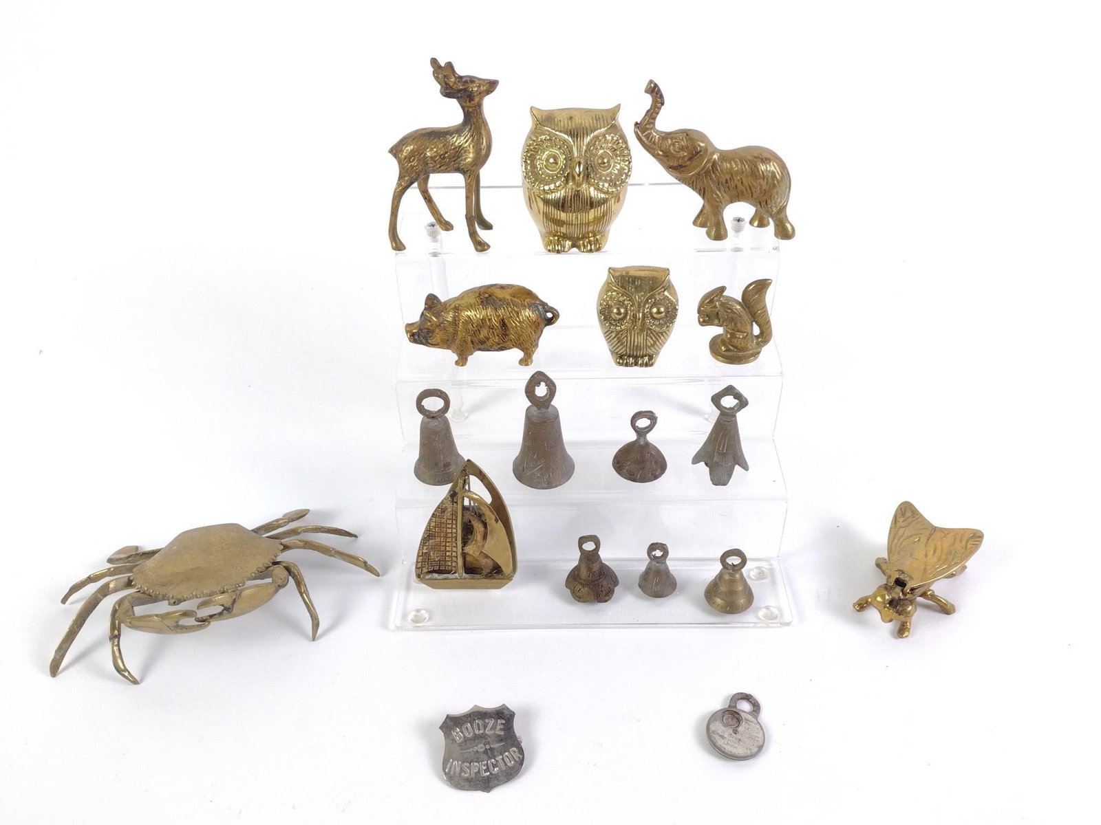 19 Metal Decorative Pcs incl Animals: 8 animal figurines (includes owl, pig, crab, and more), 1 sailboat clip, 7 bells, 1 Booze Inspector pin, and 1 Trick Lock Cigar Cutter. Some wear and tear associated with age. From 1-1/2" to 4" tall a