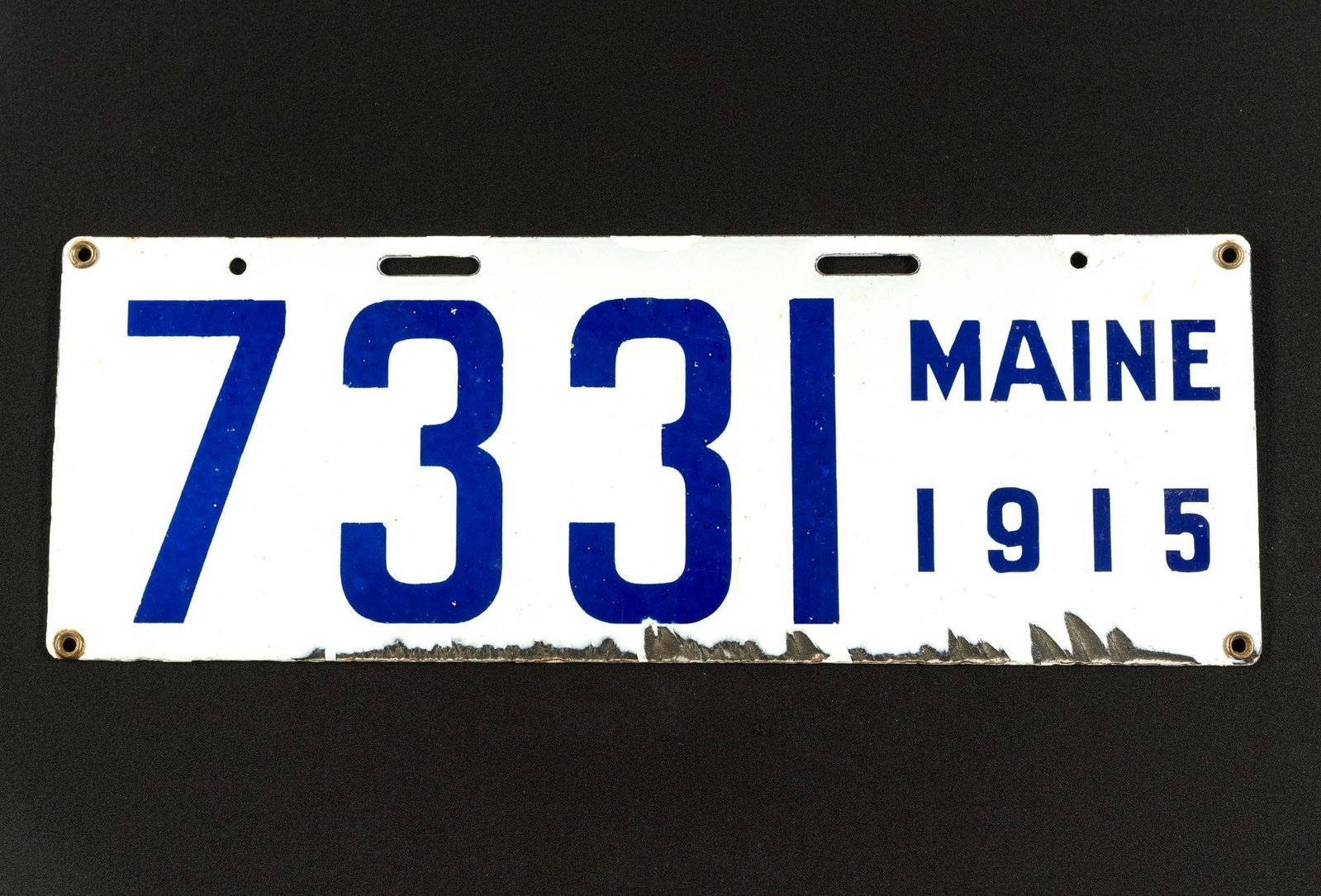 Maine 1915 License Plate: Some chips and scratches on the bottom of the plate. #7331. Back has a stamp that reads "Ing-Rich MFG. Co. Porcelain Auto Tag Beaver Falls, PA." 14-3/4" wide, 5-1/4" tall.