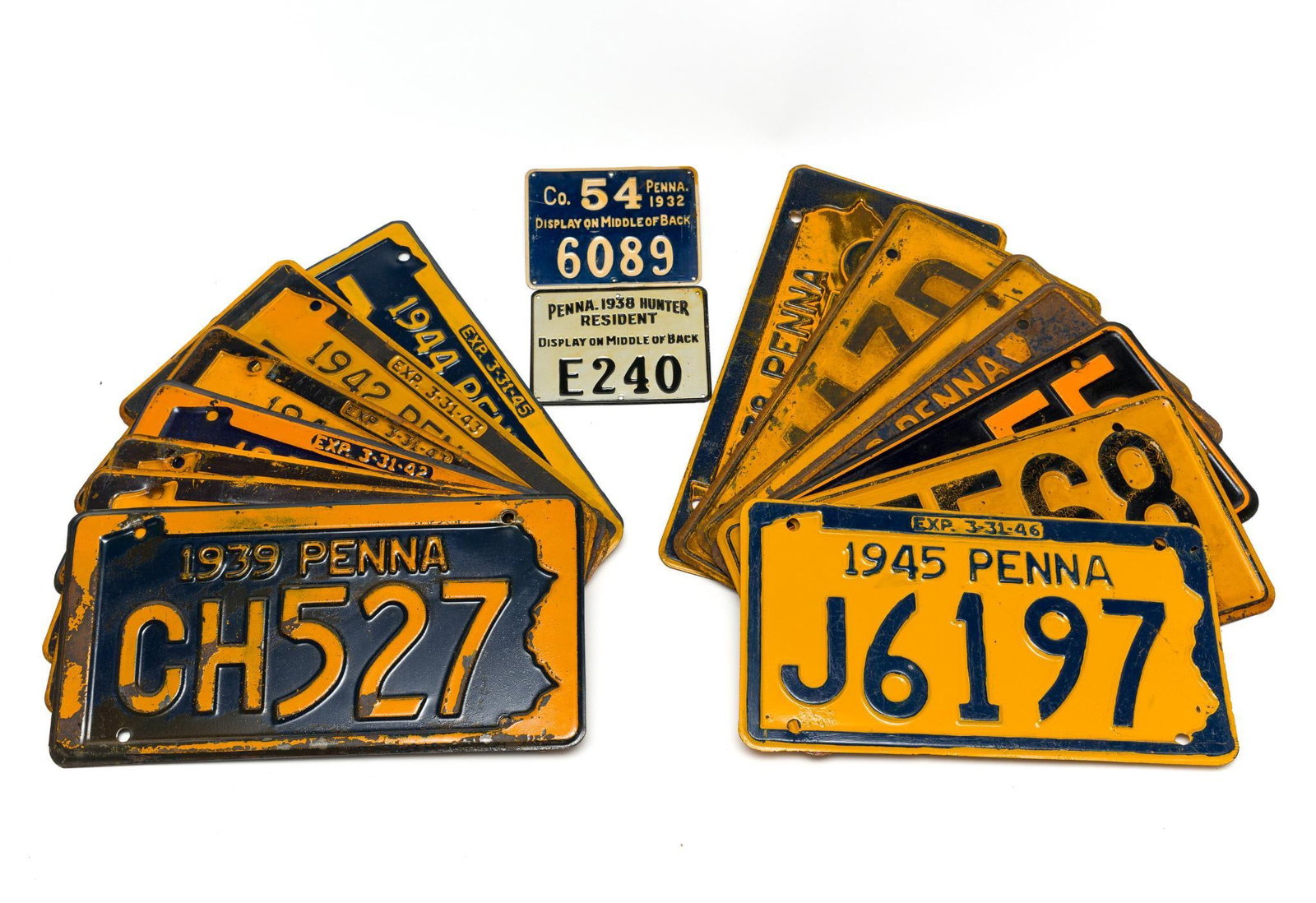 18 Pennsylvania License Plates 1930-1945: Includes pairs for some years. Two are Hunter Resident plates. Wear and tear associated with age, including paint loss and rusting. From 3-1/2" to 6" wide 4-1/2" to 12" wide.