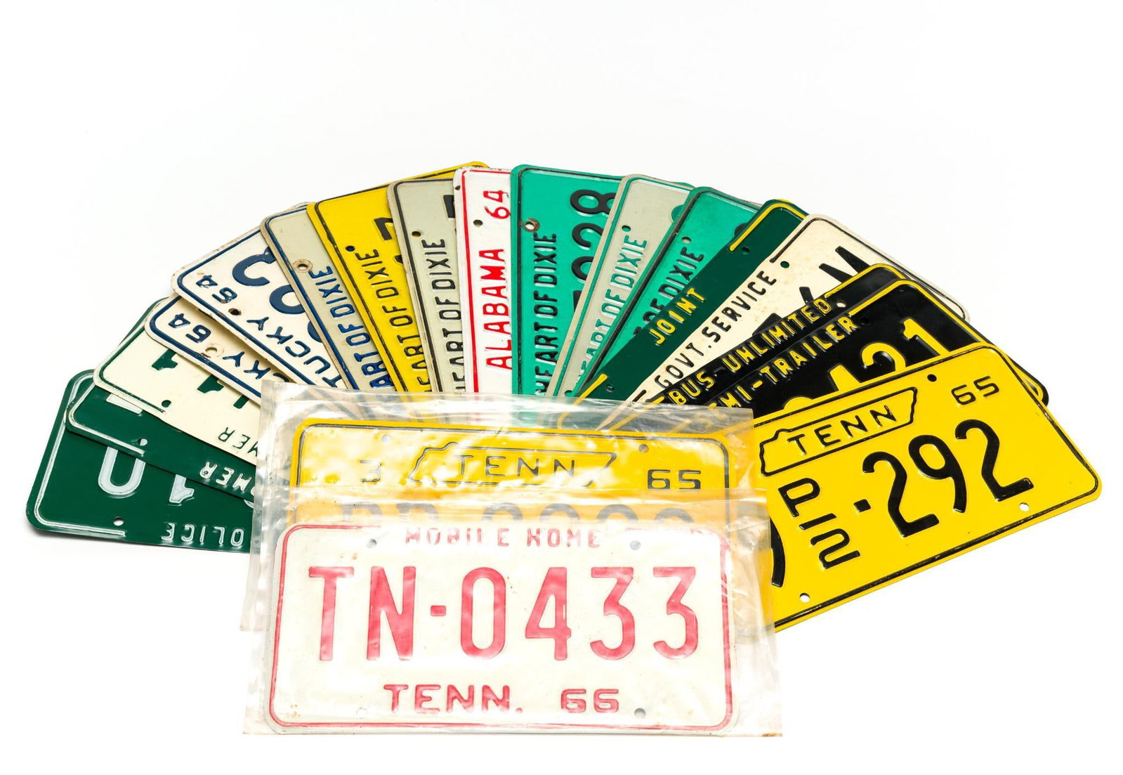 18 United States Vintage License Plates: Includes 7 Alabama (1964 - 1975), 2 Kentucky (1964), and 9 Tennessee (1965 - 1966). Normal wear and tear associated with age. All approximately 6" tall and 12" wide.