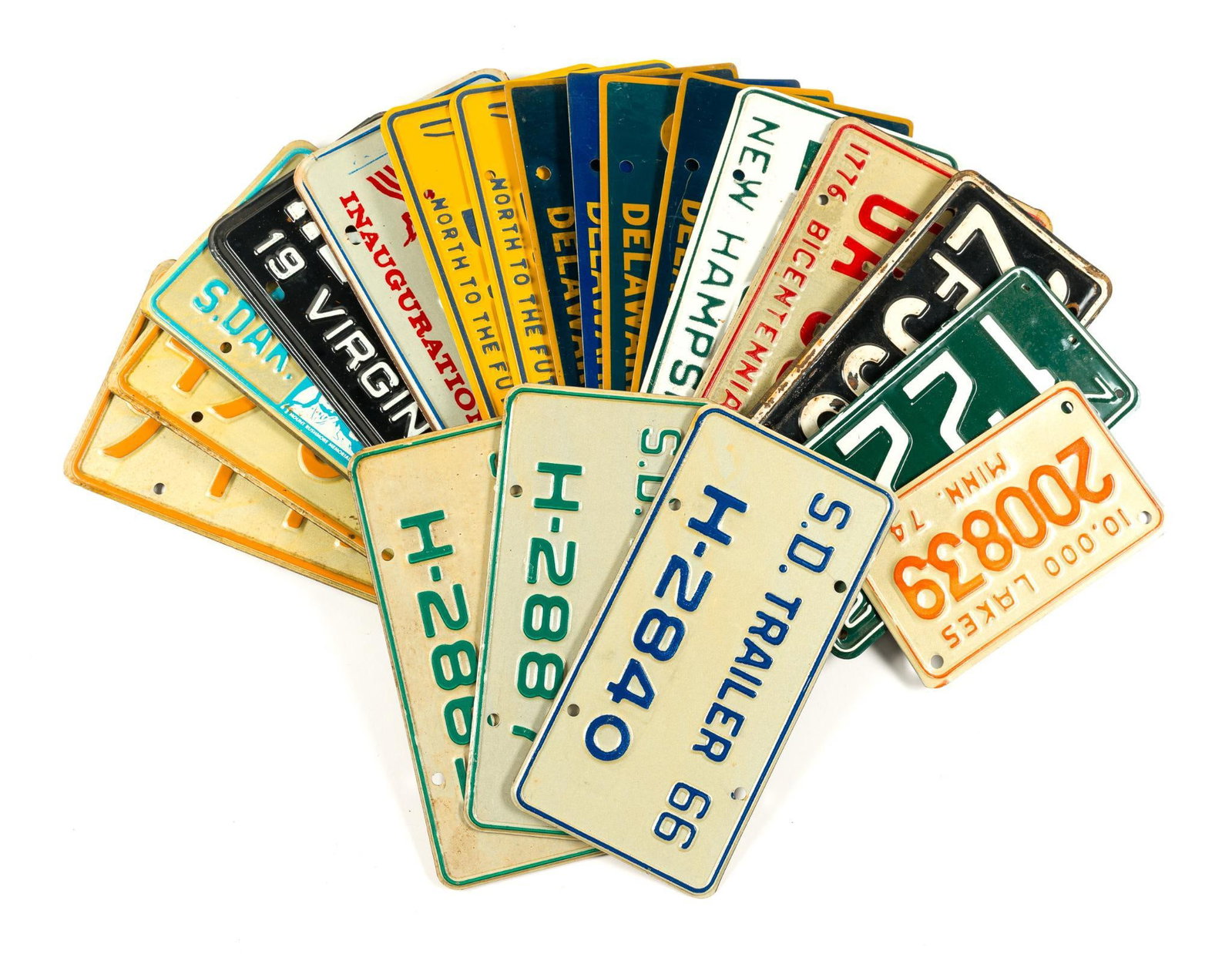 22 Vintage United States License Plates: Pair of Civilian France plates, 1 Minnesota (1974), 1 New Hampshire Boat plate (1972), 1 New Hampshire plate (1973), 4 South Dakota Trailer plates (1965 and 1966), 4 Delaware plates (1973-1975), 1 Okl