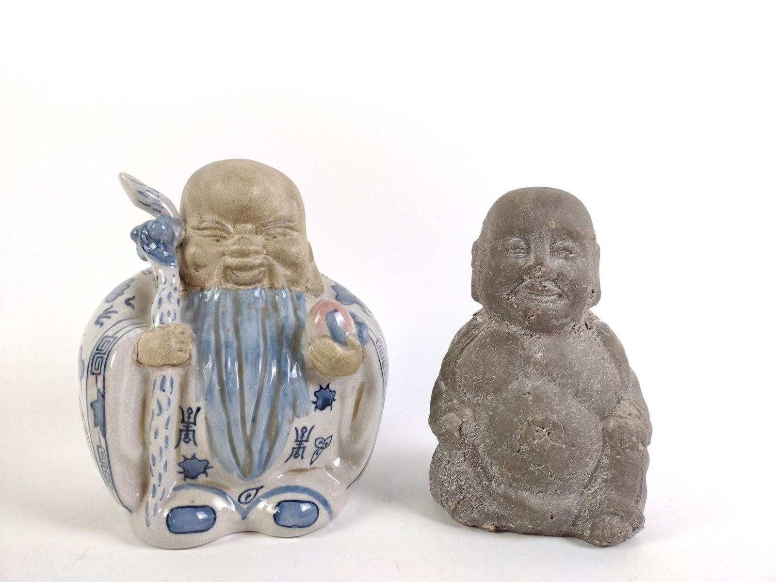 2 Asian Figurines incl. Shou Lao: Also includes Buddha. 5" to 6-1/2" wide x 7-1/2" to 7-1/4" high. PROVENANCE: From the Estate of Virginia Parkum. The Rev. Dr. Virginia "Ginny" Cohn Parkum (1943-2025) was a Harrisburg resident dedicat