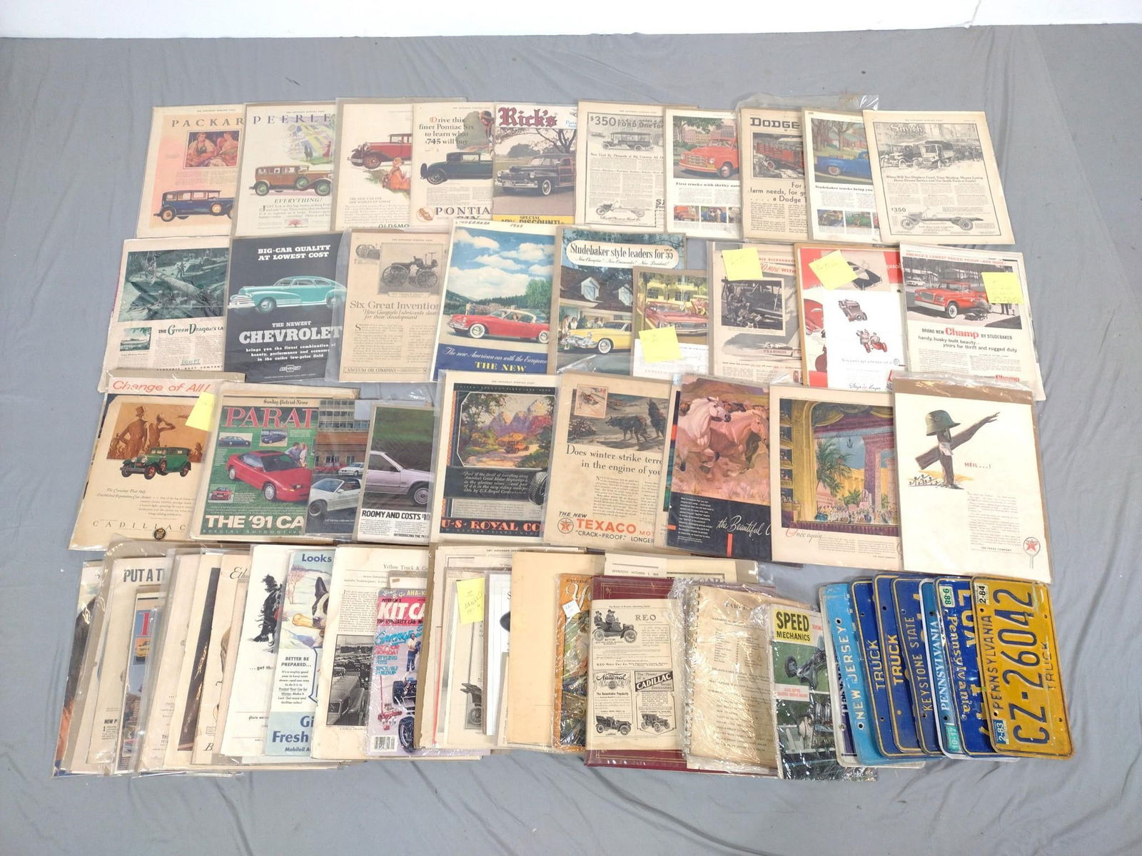Grouping of Car Ephemera and License Plates: Includes 9 license plates. Notable names include Texaco, Mobilgas, Firestone, and more. Normal signs of wear and tear associated with age.