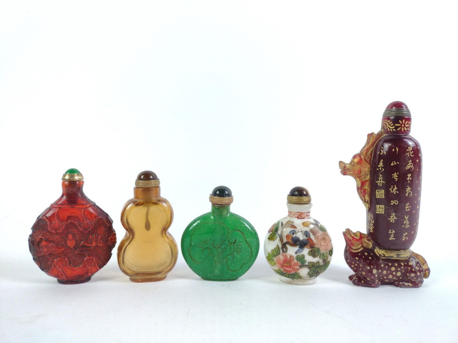 5 Snuff Bottles: Includes glass and porcelain. One in box. One missing spoon. From 2-1/2" to 5-1/2" tall and 1-1/2" to 3-1/4" wide.