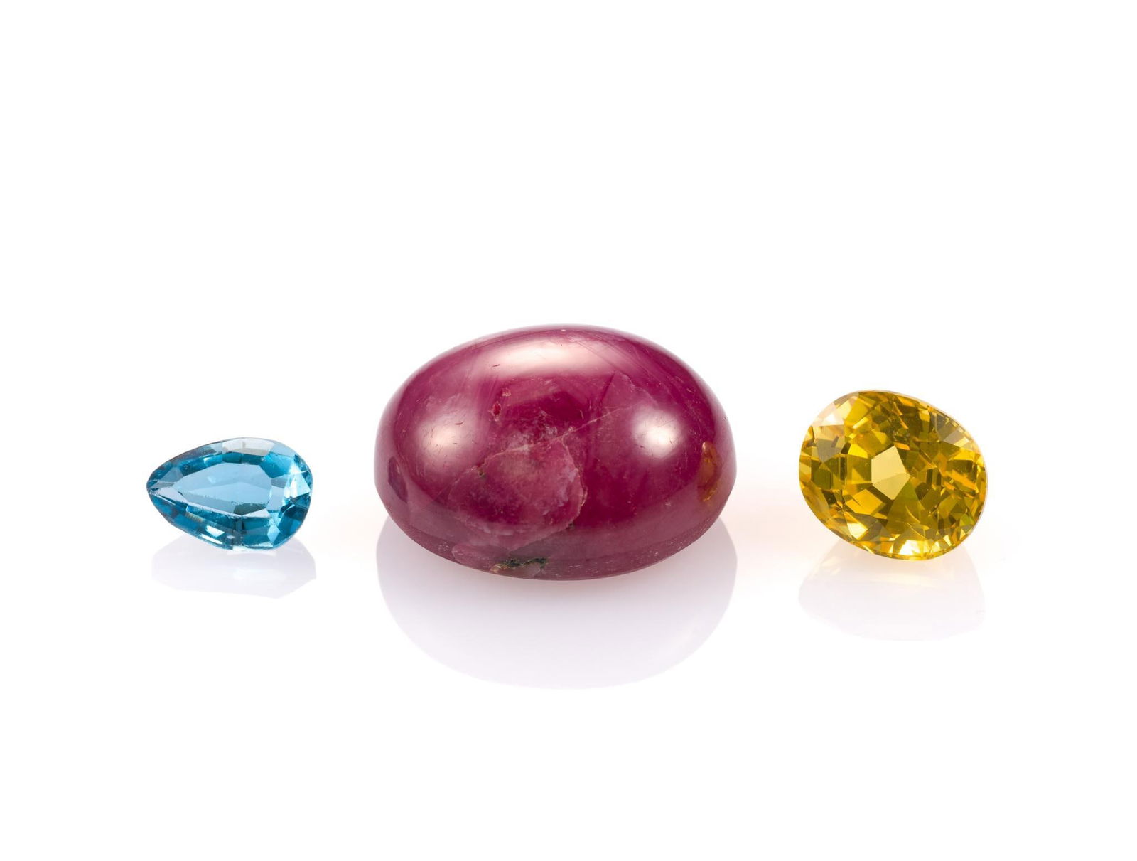 3 Unmounted Gemstones: Includes (1) Sapphire, oval, 2.72 carats, VVS, heated; (2) Star Ruby, oval cabochon, 16.99 carats, opaque, heated; and (3) Topaz, pear, 0.87 carats, VVS, heated. From a selection of fine gemstones of