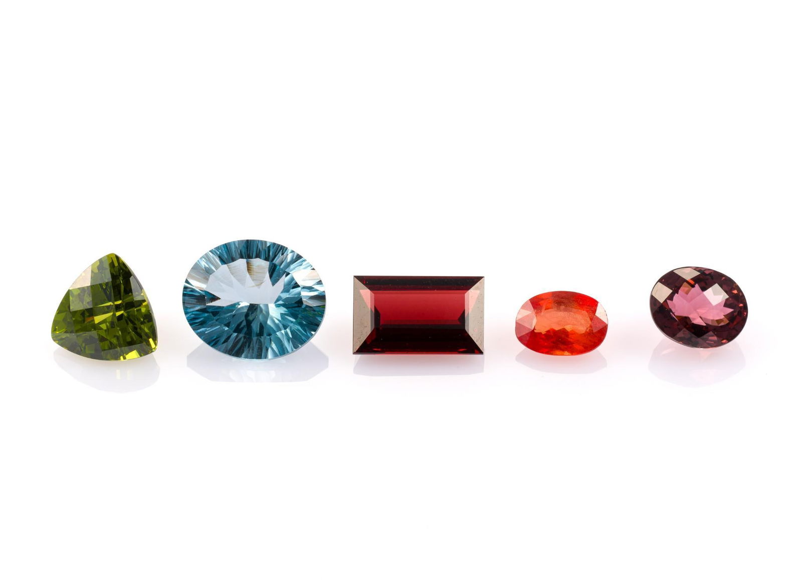 5 Unmounted Gemstones: Includes (1) Tourmaline, oval checker, 2.96 carats, VS, no treatment; (2) Spessartite Garnet, baguette, 4.39 carats, VS, unheated; (3) Peridot, trillion, 5.19 carats, VS, natural; (4) Topaz, oval conc