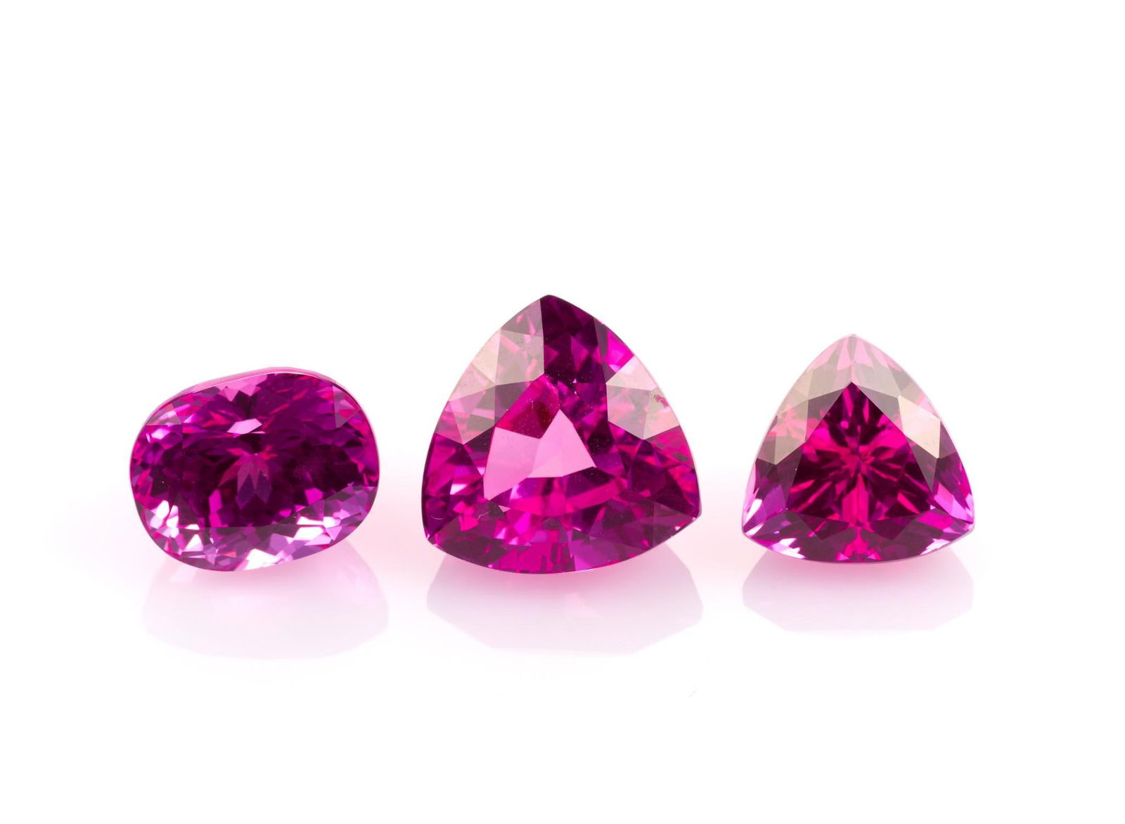 3 Unmounted Topaz: Includes (1) Topaz, trillion, 12.2 carats, IF, enhanced; (2) Topaz, trillion, 20.3 carats, IF, enhanced; and (3) Topaz, oval, 14.7 carats, IF, enhanced. From a selection of fine gemstones of a retirin