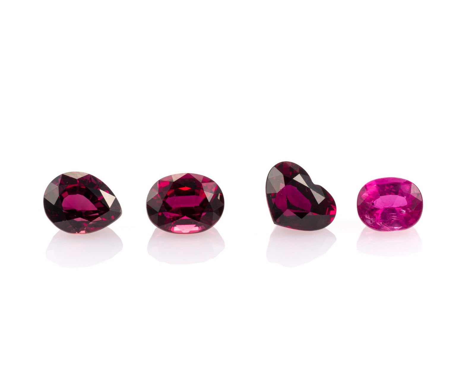 4 Unmounted Gemstones: Includes (1) Sapphire, oval, 1.16 carat, natural; (2) Ruby, pear, 1.55 carats, natural; (3) Ruby, heart, 1.64 carat, natural; and (4) Ruby, oval, 1.75 carat, natural. From a selection of fine gemstone