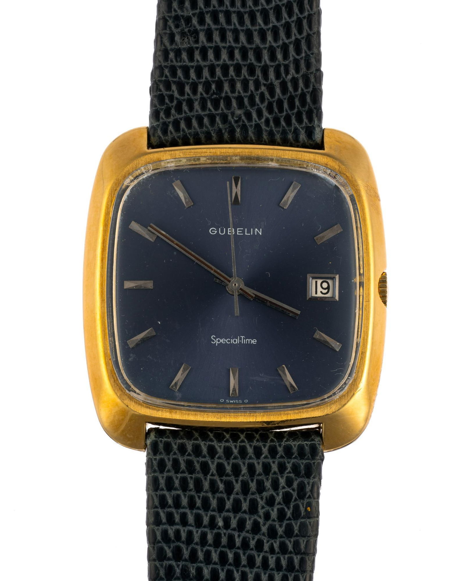18K Gold Gubelin Wrist Watch: A heavy cushion-cased Gubelin wrist watch with yellow gold case and navy blue dial. The watch is automatic and runs and keeps time. The gold weight of the case is 35.6 grams. That is the weight withou