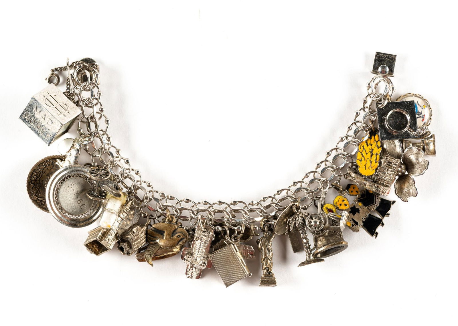 Sterling Silver Charm Bracelet: A 7" charm bracelet with numerous charms, apparently all sterling but not checked one by one. None were seen that were not sterling. Total weight is 2.8 troy ounces.