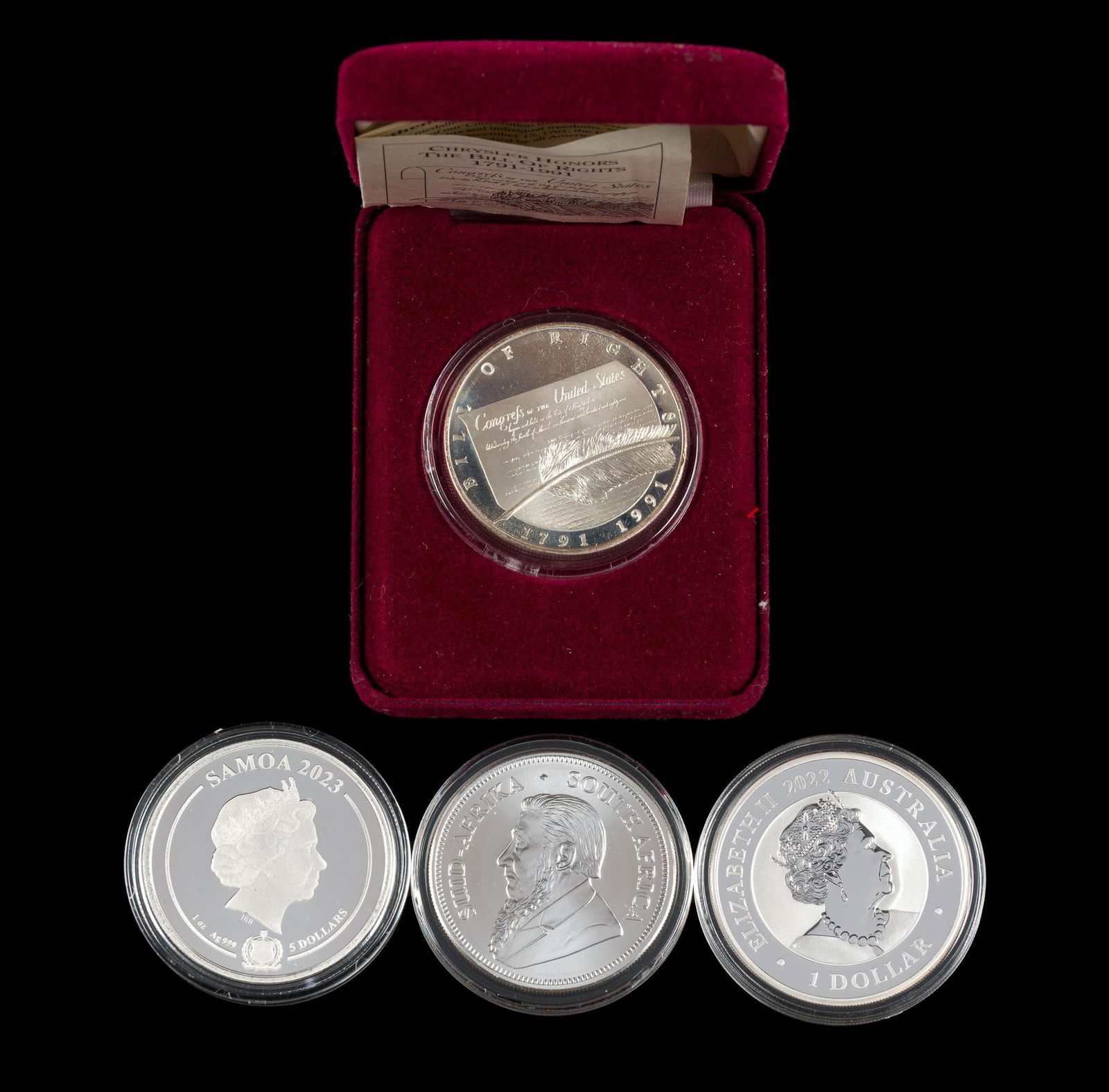 Four One Ounce Silver Commemorative Coins: Chrystler Bill of Rights 1991, Samoa 2023, Australia 2022 1 Dollar, 2022 silver Krugerand. Each are one ounce pure silver.