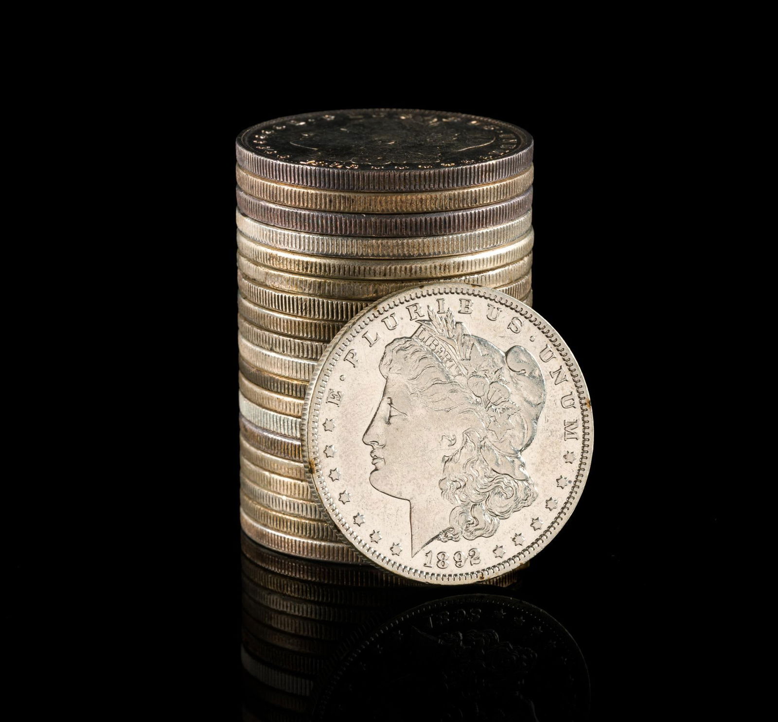 Twenty Silver Morgan Dollars: Most coins showing evidence of past cleaning/polishing.