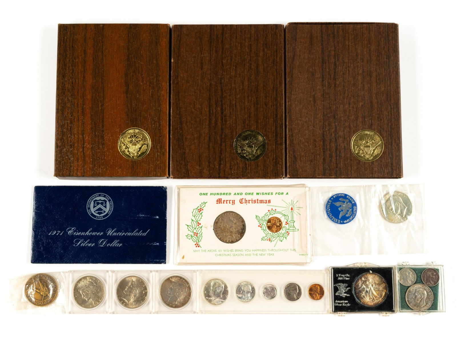 U.S. Silver Coins Including Peace And Morgan Dollars American Eagle: Five Eisenhower silver dollars with three being proofs and two uncirculated. Three Peace dollars and one Morgan dollar. One 1988 American Eagle silver dollar one ounce silver with toning. One 1964