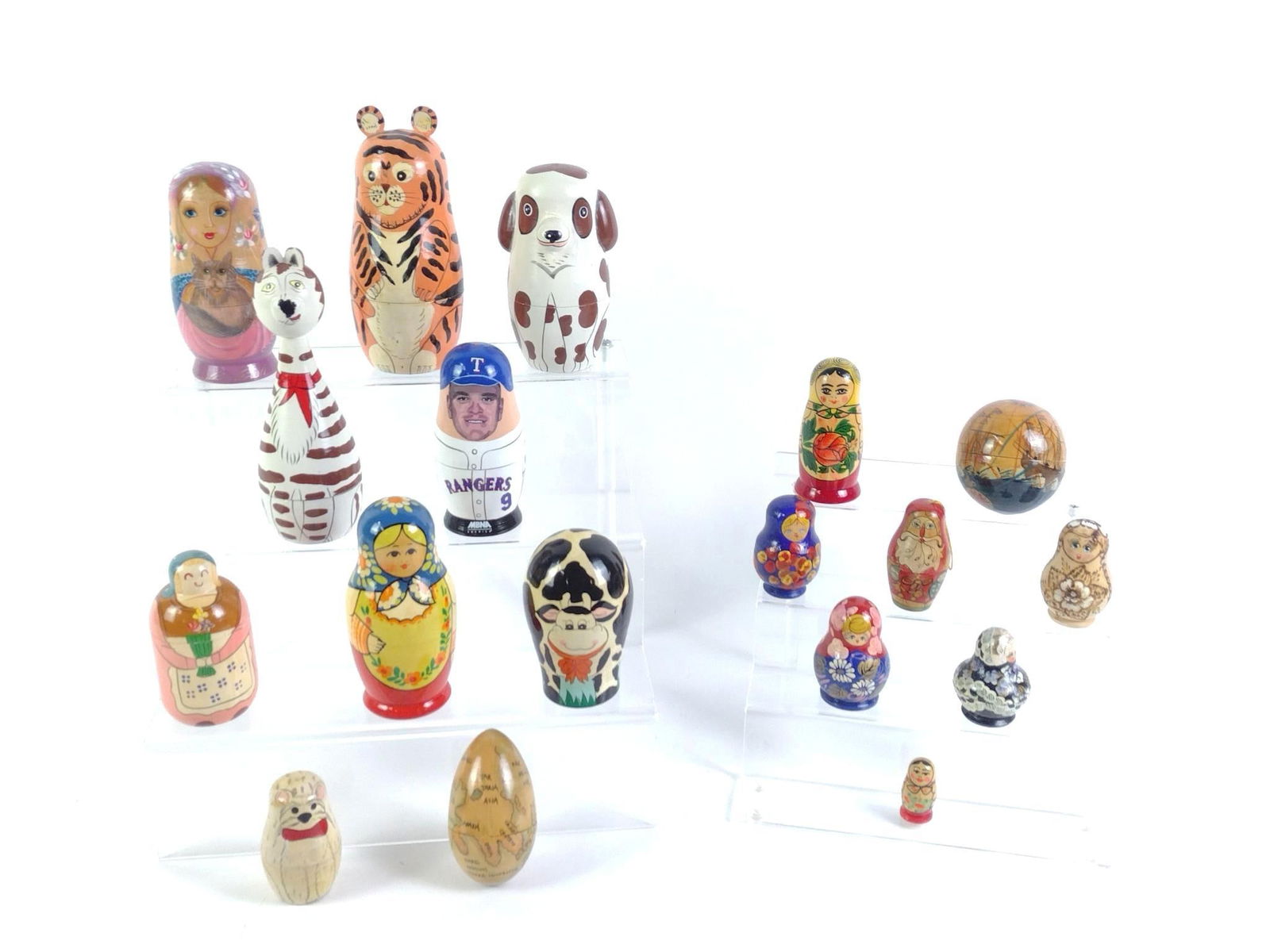 18 Russian & Chinese Nesting Dolls: Includes themed animals, people, maps, and more. Some marked made in Russia and others marked made in China. 1-1/2" to 7" tall overall.