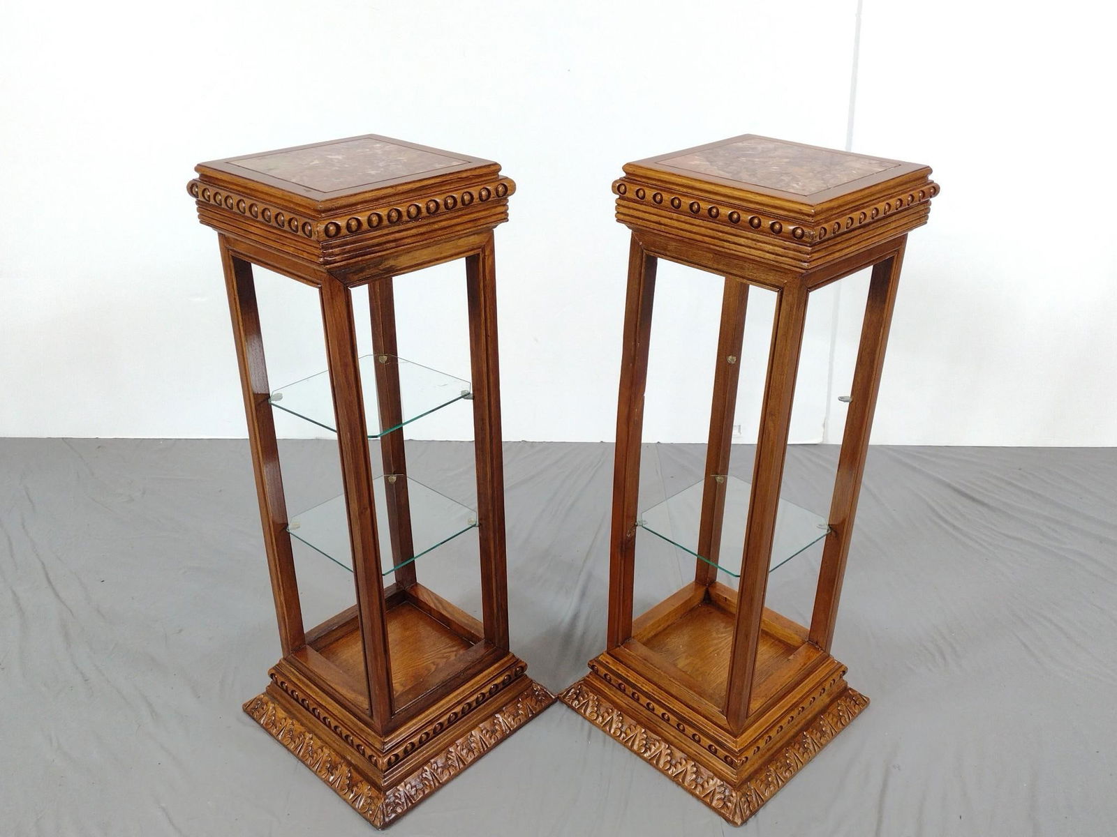 Pair Of Marble Top Stands: NOT ELIGIBLE FOR IN-HOUSE SHIPPING: See Terms for Shipping Options. Each 14-1/2" wide X 14-1/2" deep X 35-3/4" high. Missing one glass shelf. No manufactures name found.