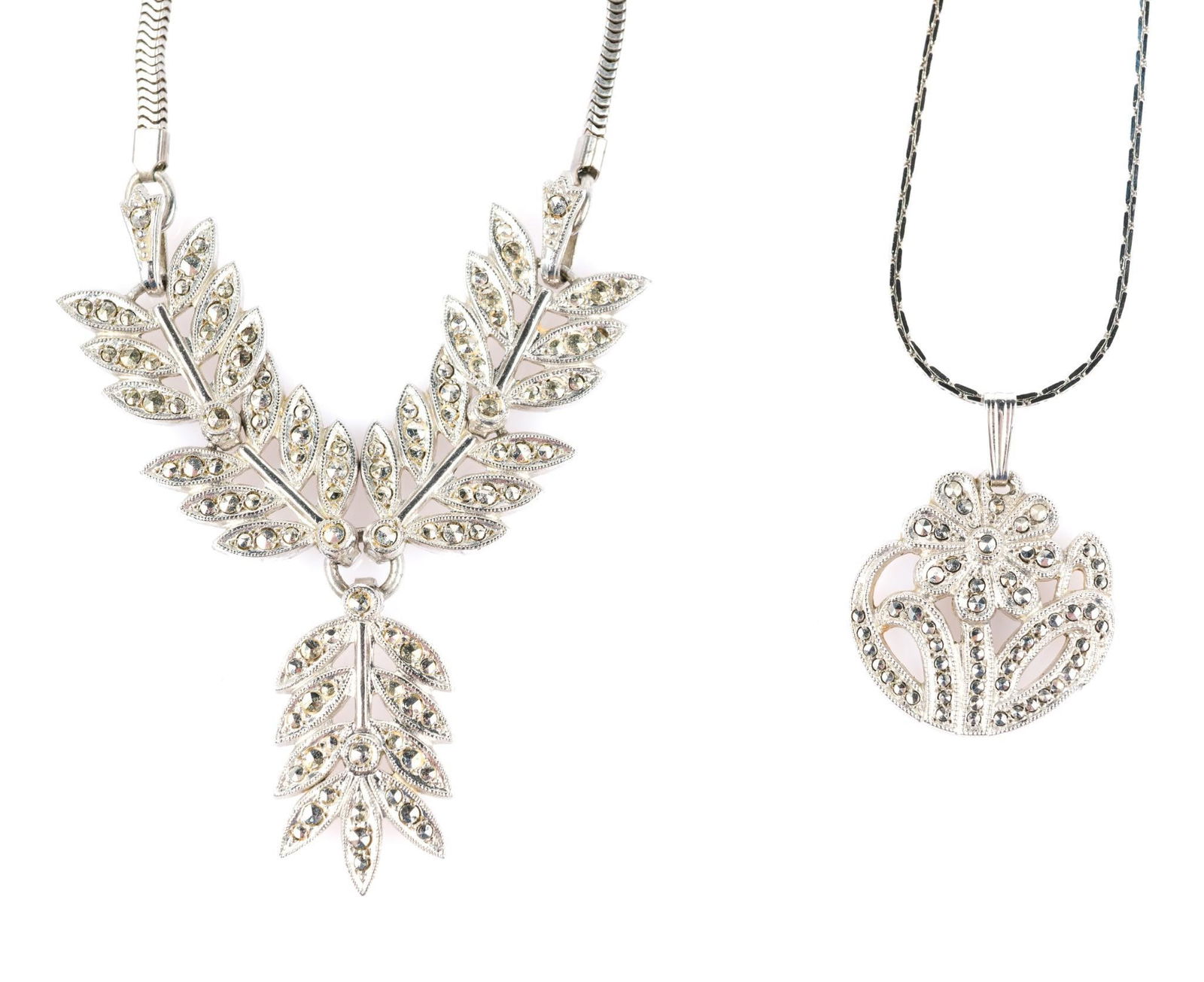 2 Sterling and Marcasite Necklaces: One pendant is marked "K D Sterling", second pendant marked sterling on loop. Chains not sterling. 8-1/2" to 12-1/2" long overall. 18-1/4" to 24" long.