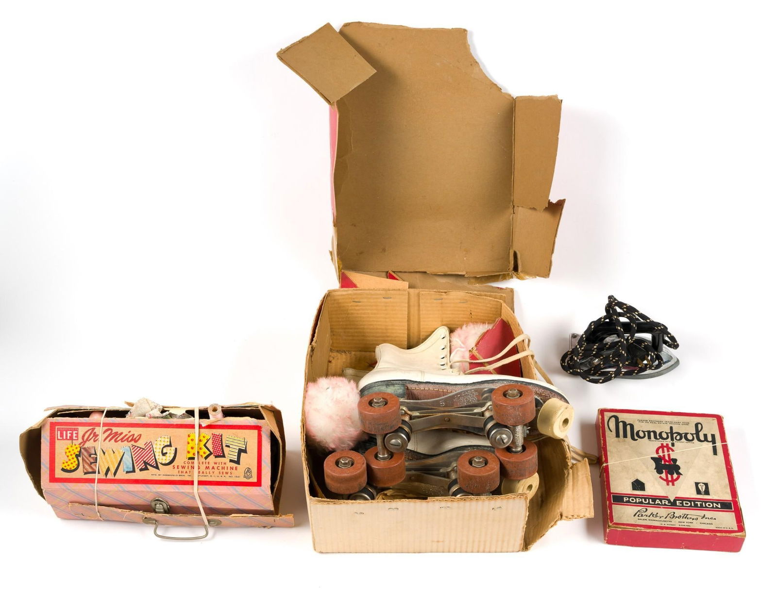 4 Pcs Vintage Children's Toys Incl Roller Skates: Includes Jr. Miss Sewing Kit (box in poor condition but appears complete), children's electric iron, Monopoly Popular Edition (1940s) (note: does not have a full set of cash), and vintage Chicago