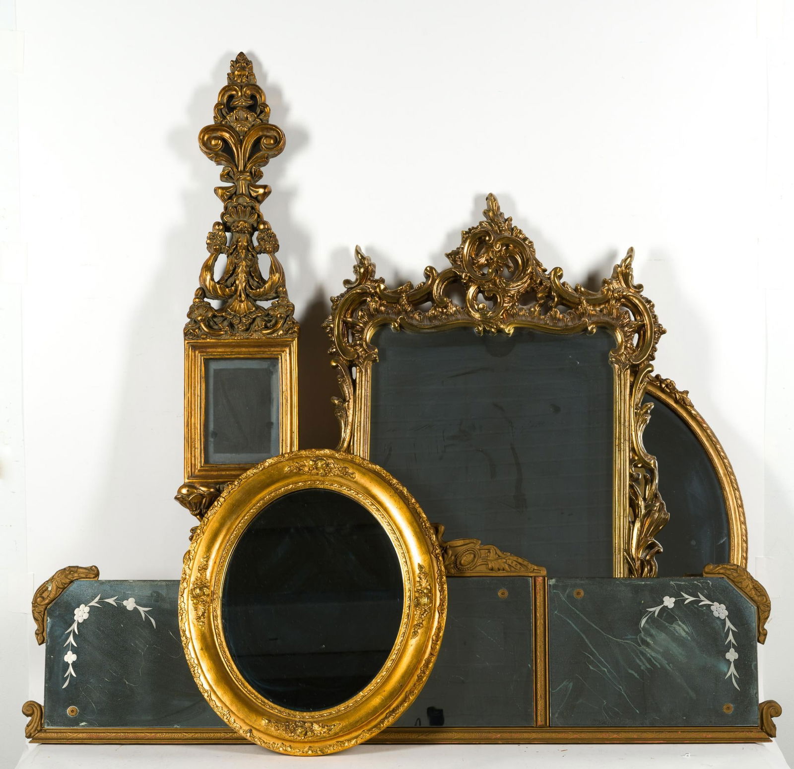 Five Mirrors With Ornate Gold Frames: NOT ELIGIBLE FOR IN-HOUSE SHIPPING: See Terms for Shipping Options. Most are reproduction cast frames. The smaller oval mirror is vintage gilt gold on wood frame, 21 1/4" height. The longest mirror